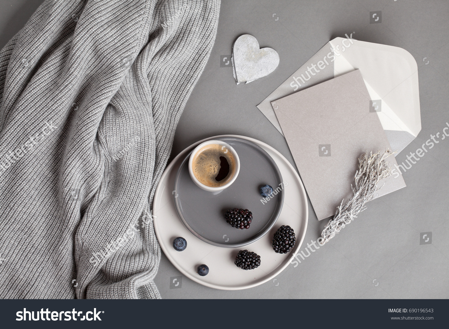 Top view over coffee cup  and gray postcard with envelope