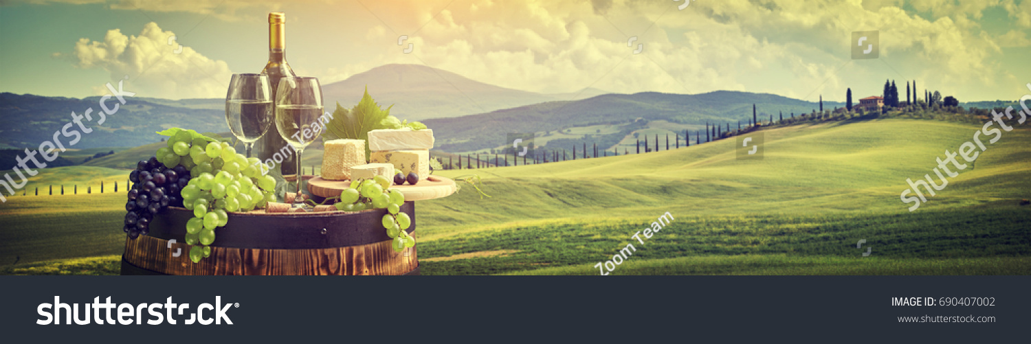 Red wine with barrel on vineyard in green Tuscany  Italy