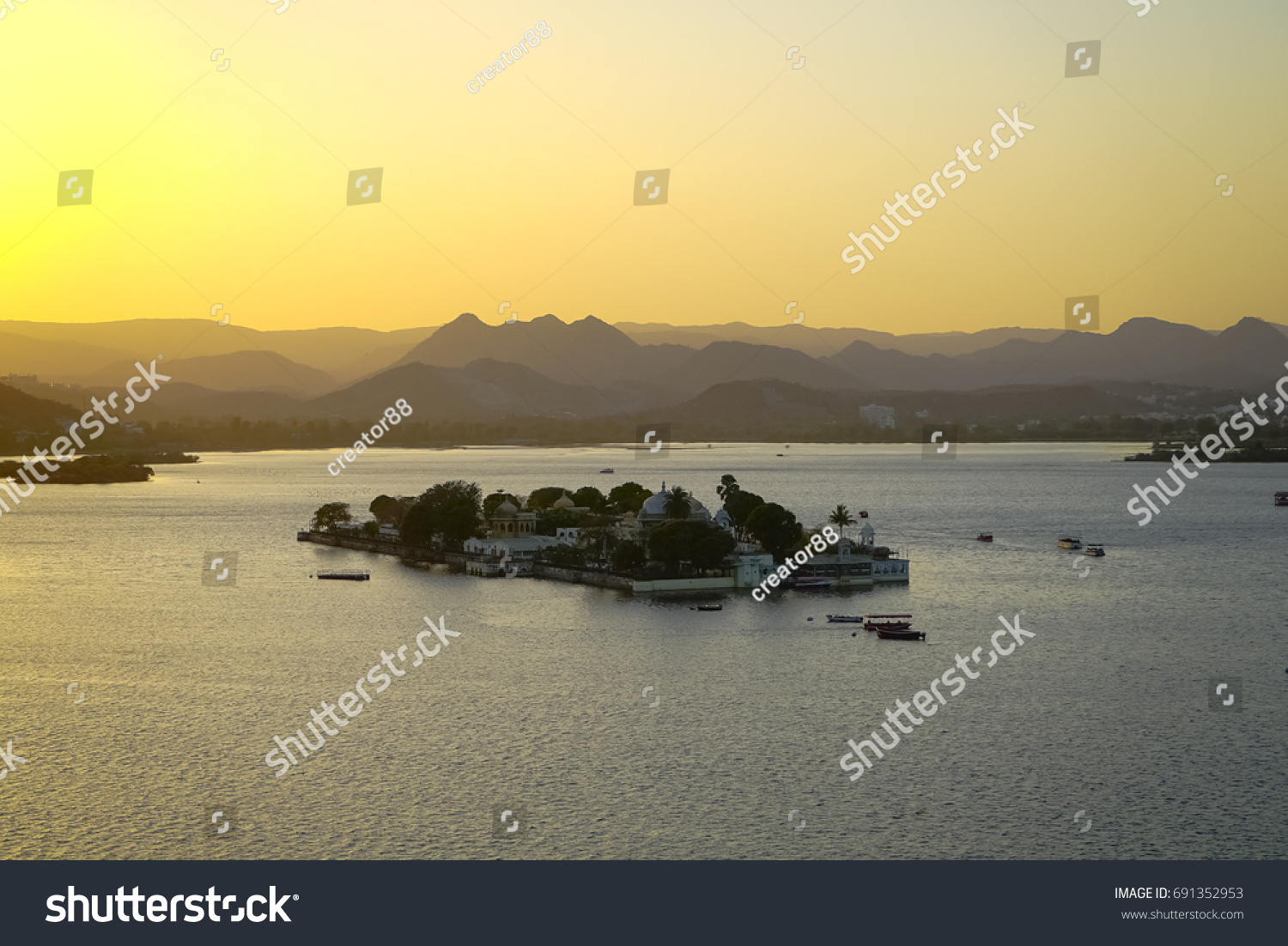 Jagmandir island with architectural buildings on Pichola lake in Udaipur city at sunset time. Rajasthan. India.