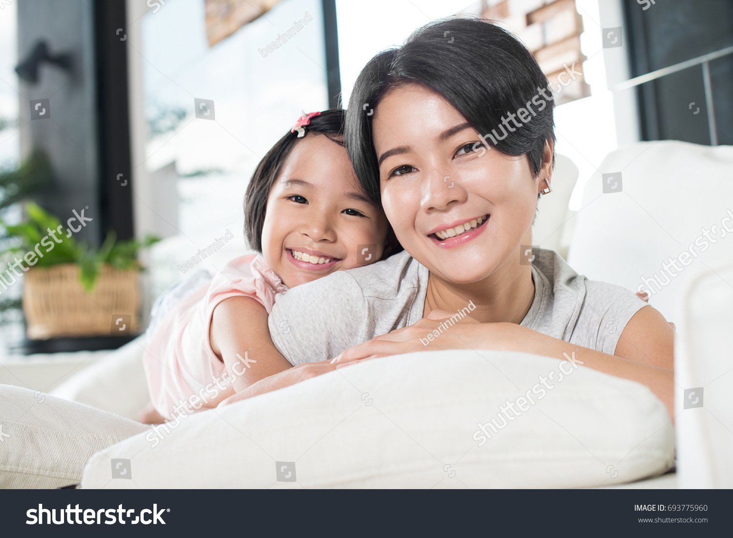 Young Asian mother and daughter at home.