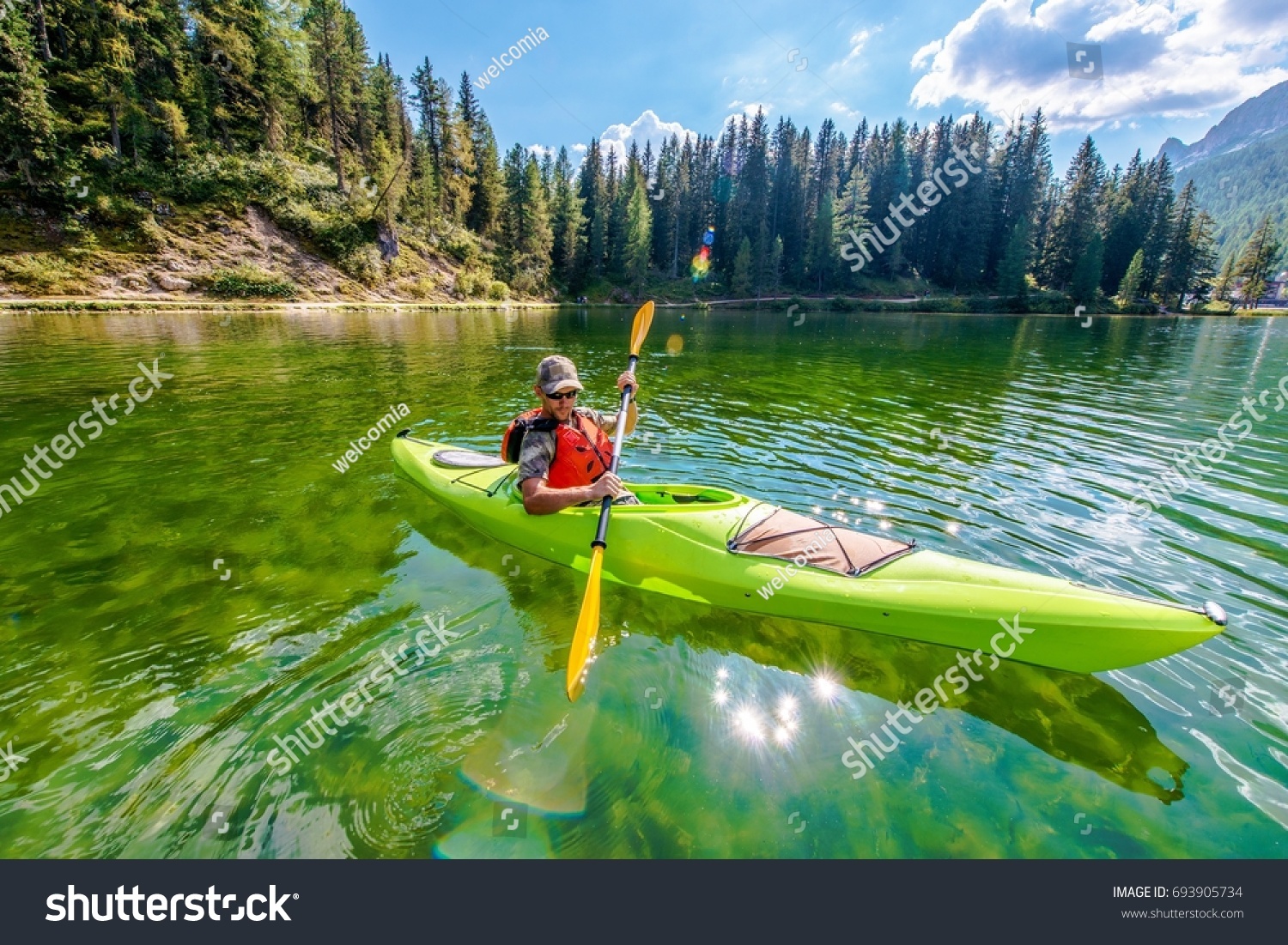 Shallow Scenic Lake Kayak Tour. Caucasian Kayaker on the Lake Misurina in Northern Italy. Italian Dolomites.
