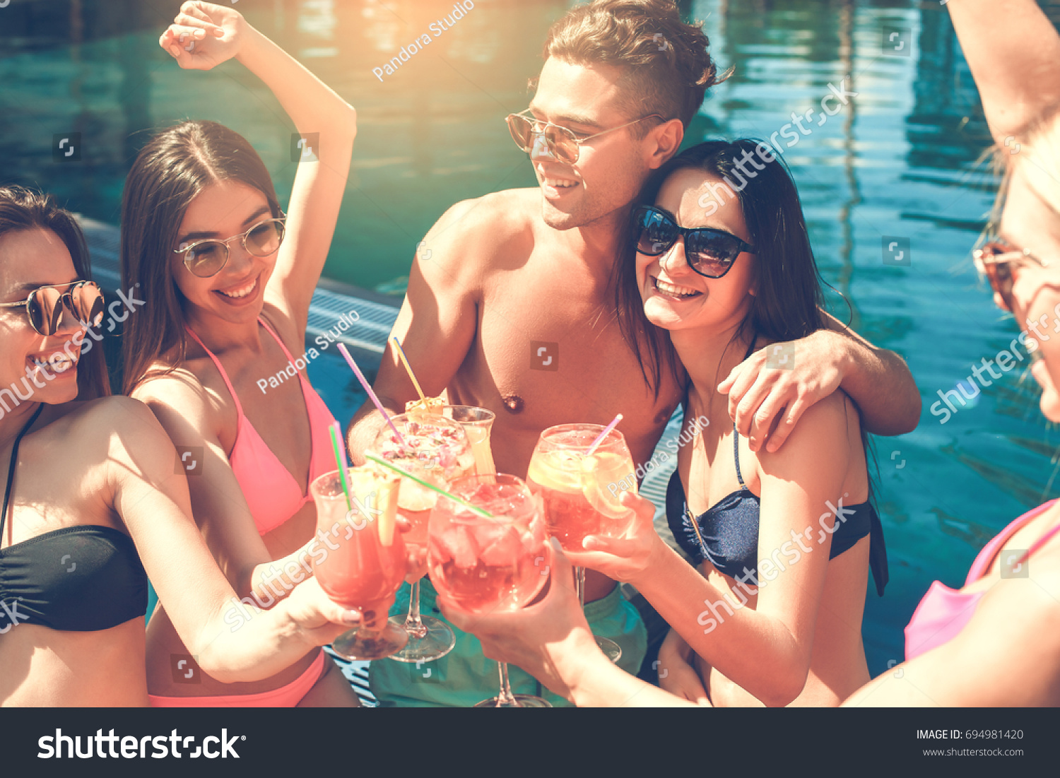 Group of friends together in the swimming pool leisure