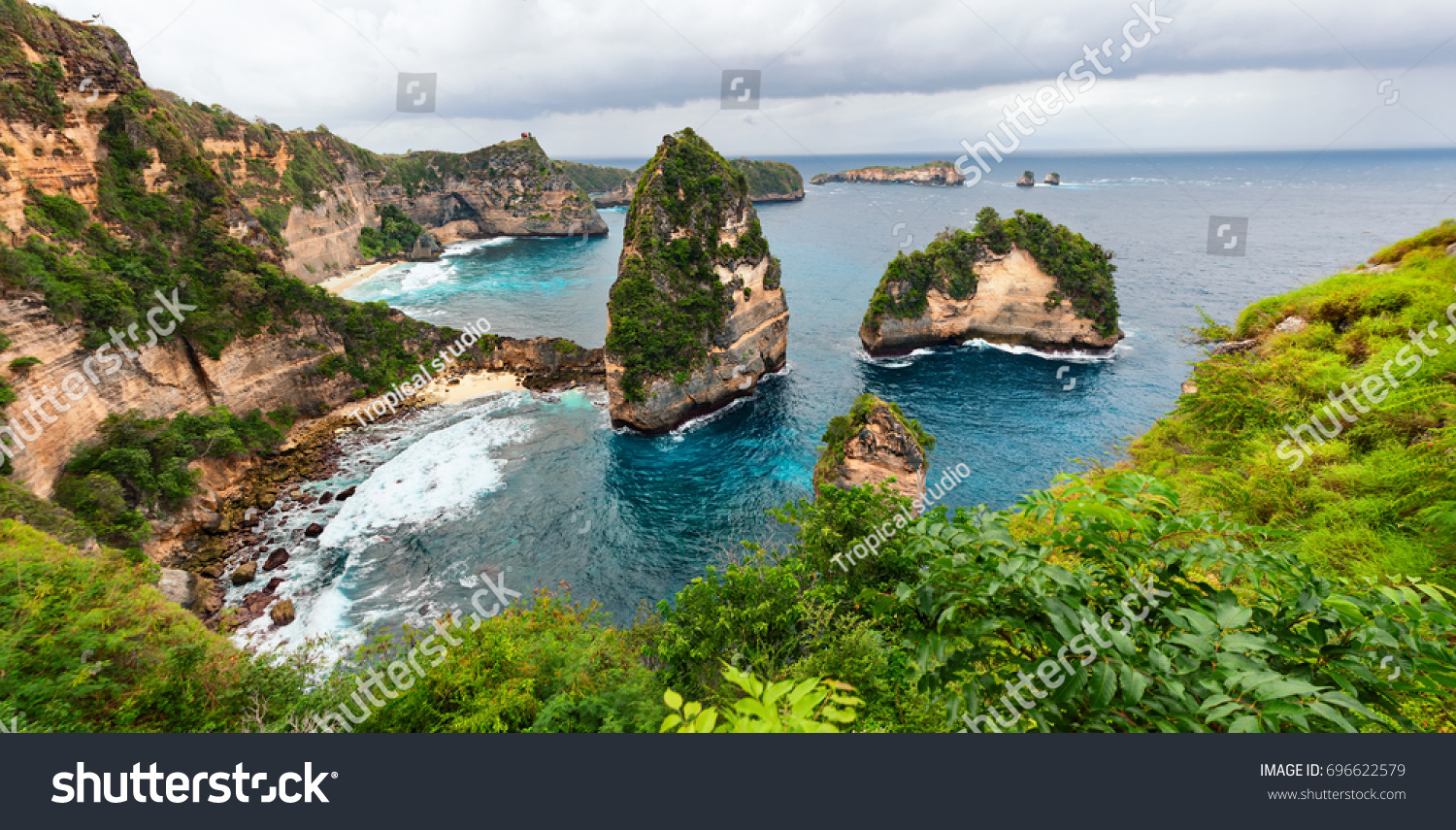Sea coast view with little house standing on the high cliff bring above sea and little rocky islets. Atuh beach  Nusa Penida island. Popular travel destination on Bali holidays. Indonesian background.