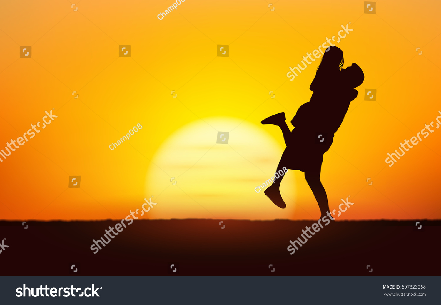 Silhouette couple man lifting woman up in his arm under sunset sky background