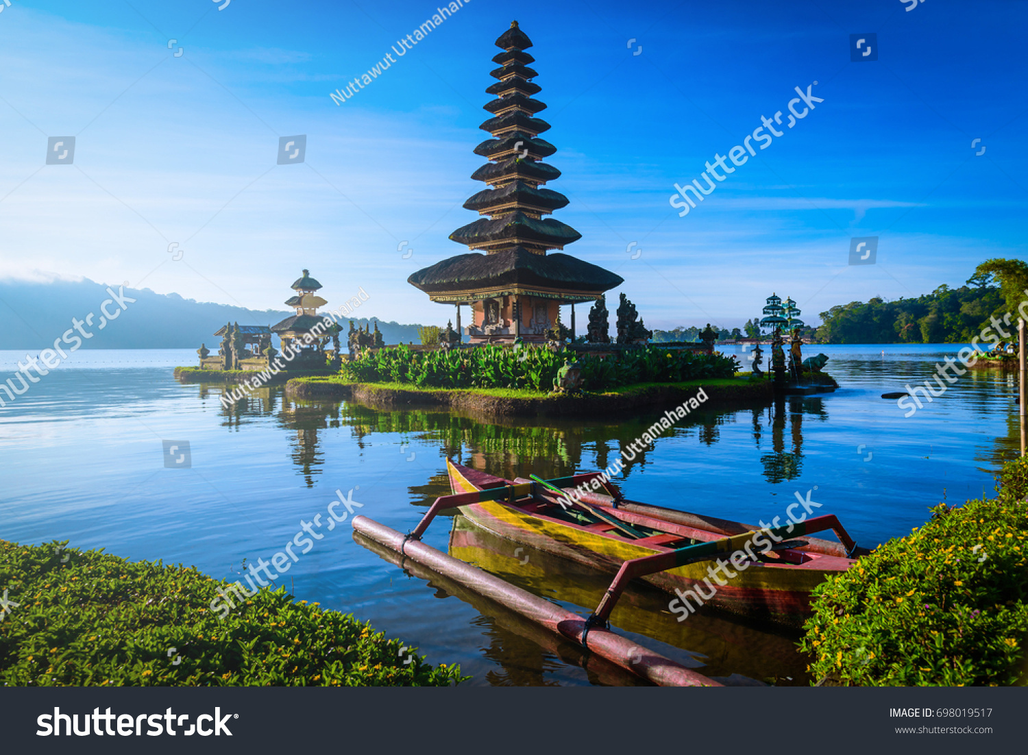 Pura Ulun Danu Bratan  Hindu temple with boat on Bratan lake landscape at sunrise in Bali  Indonesia.