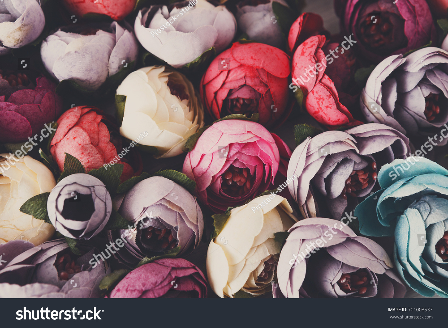 Beautiful artificial flowers variety close up. Lots of handmade fabric blossom floristic and handicraft background.