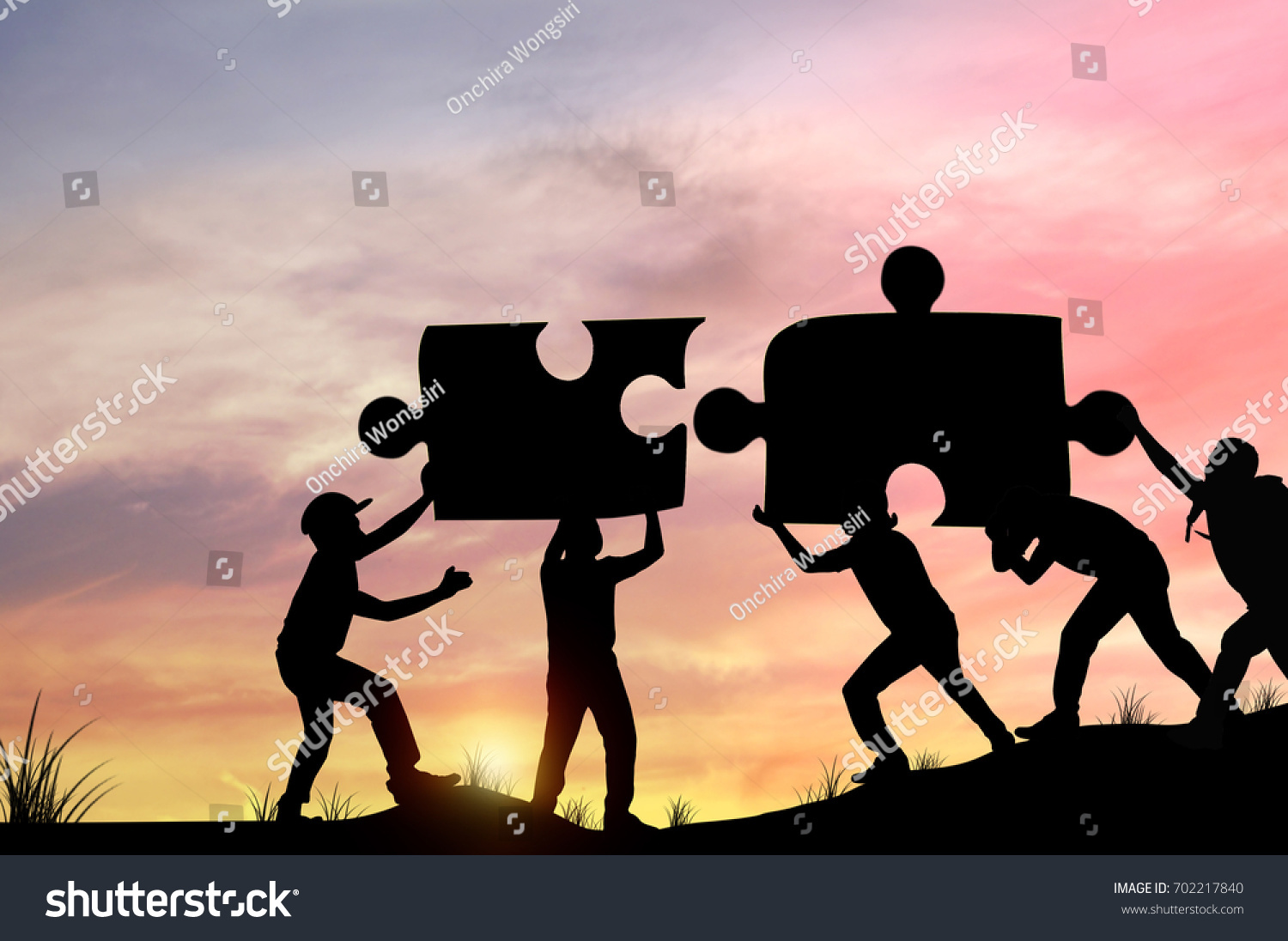 Silhouette people helping to connect jigsaw and puzzle to success  concept as improving and development business