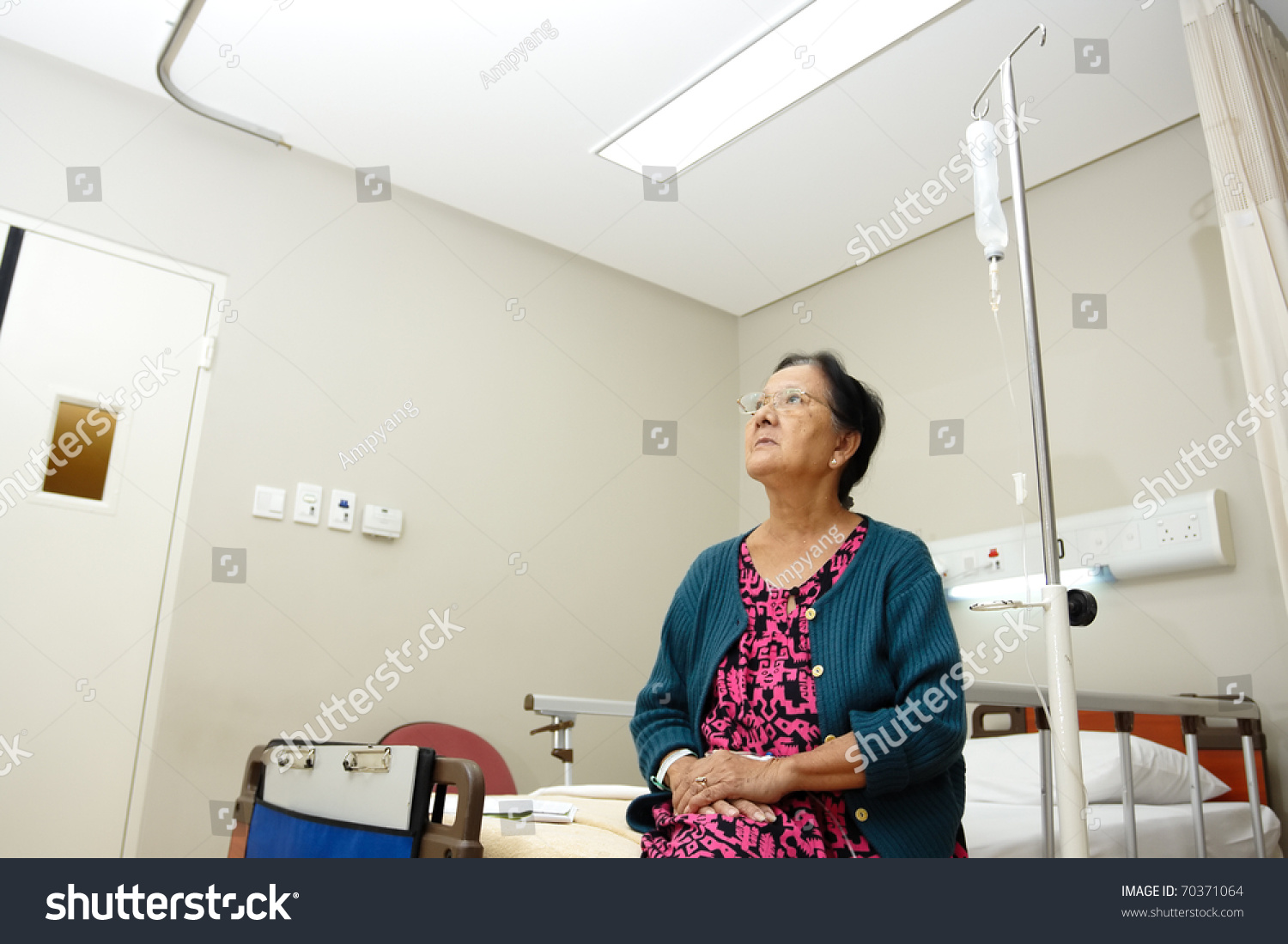 asian ethnic elderly patient woman alone in hospital ward