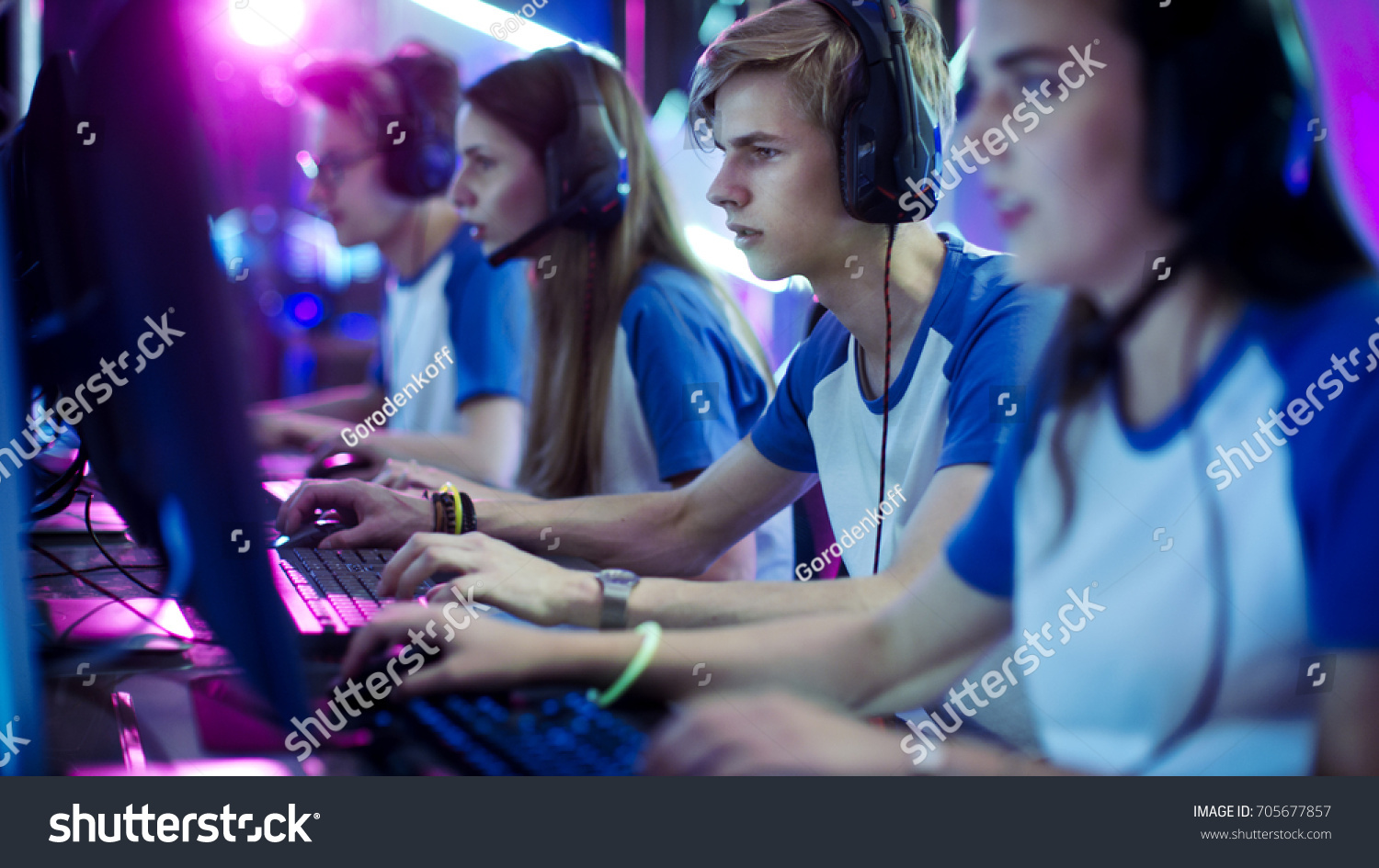 Team of Professional eSport Gamers Playing in Competitive Video Games on a Cyber Games Tournament. They using Microphones.