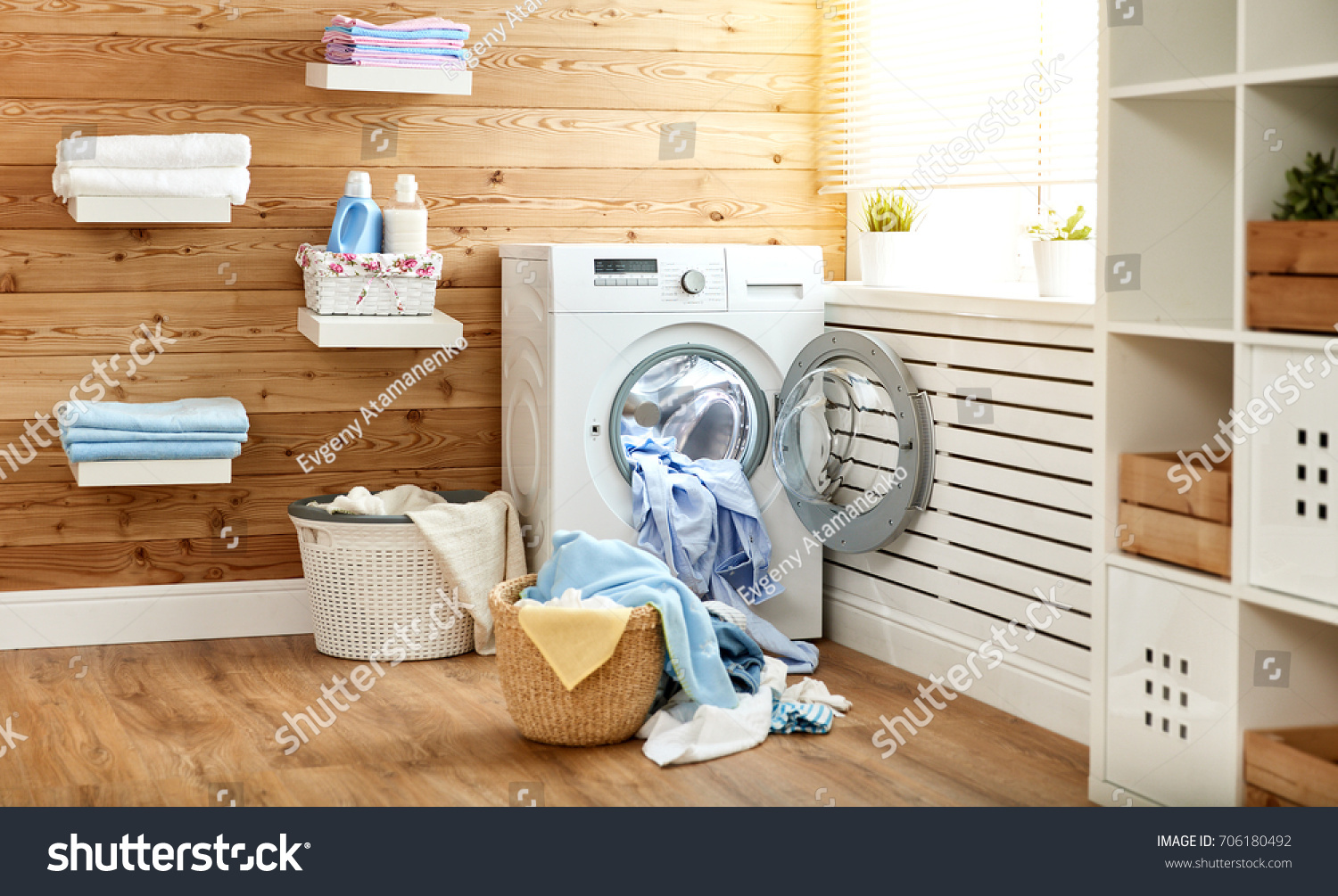 Interior of a real laundry room with a washing machine at the window at home
