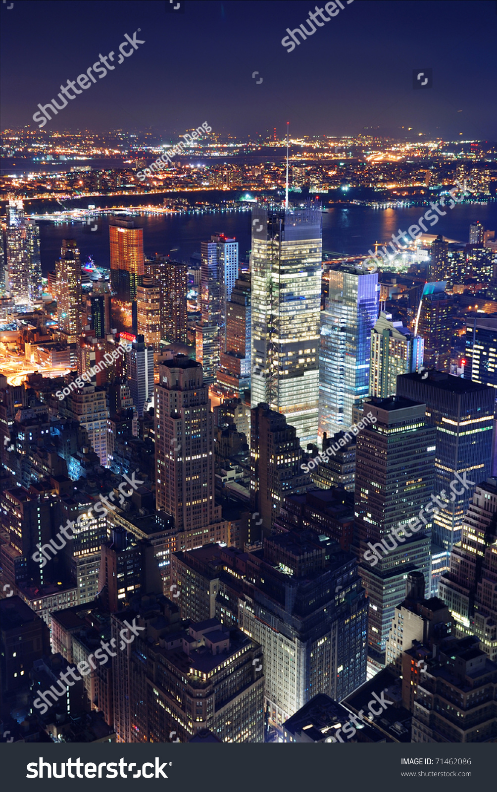 New York City Manhattan Times Square panorama aerial view at night with office building skyscrapers skyline illuminated by Hudson River.