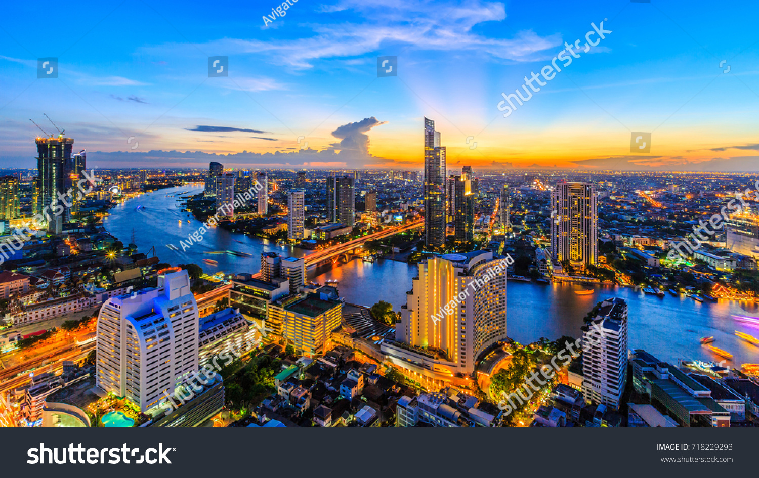 Aerial view of Bangkok City modern office buildings condominium hotel in Bangkok city downtown business and finance with Chao Phraya River during sunset sky Bangkok Thailand.