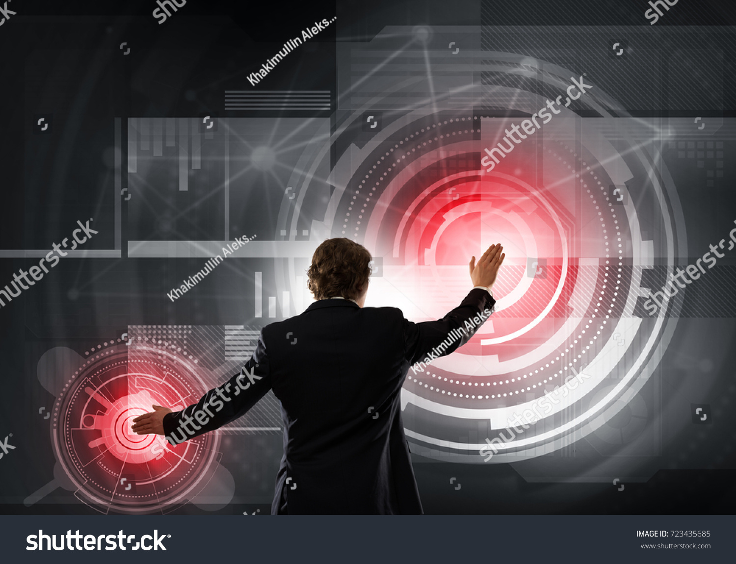 Businessman standing with back and using media virtual screen