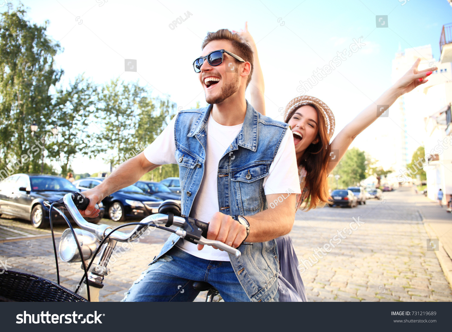 Happy funny young couple riding on bicycle. Love  relationship  romance concept.