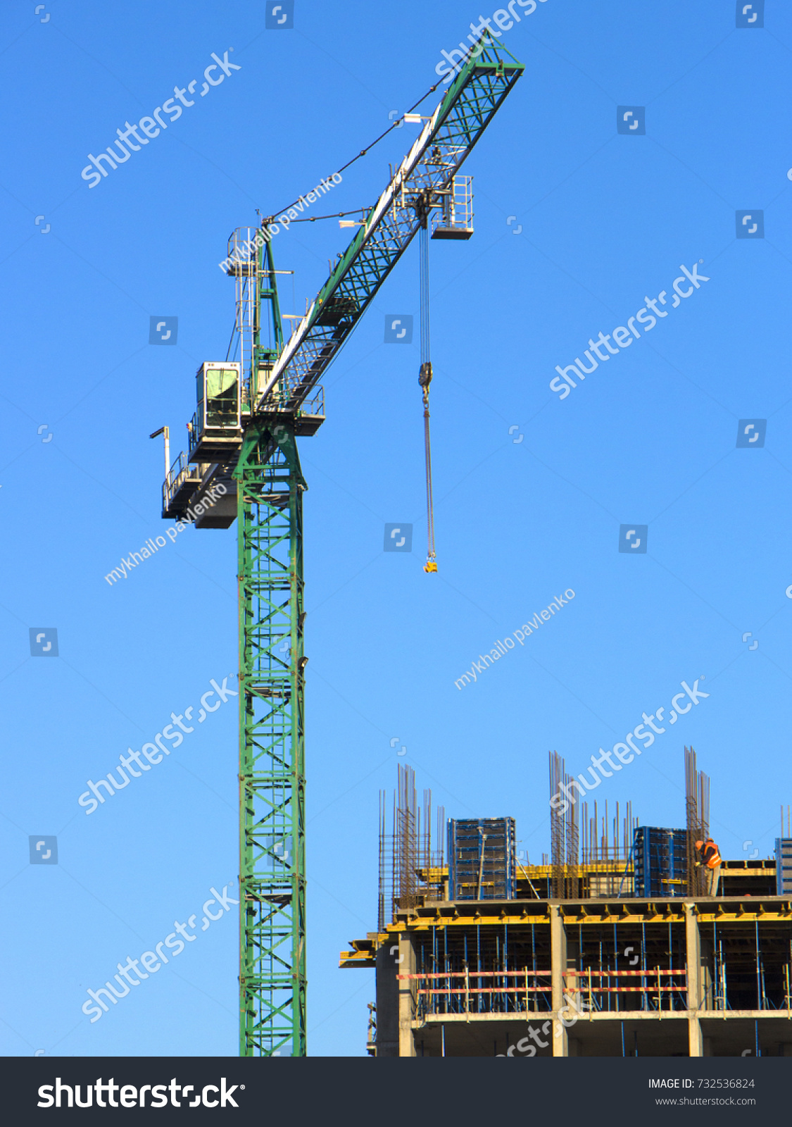 buildings construction site with three working tower cranes back