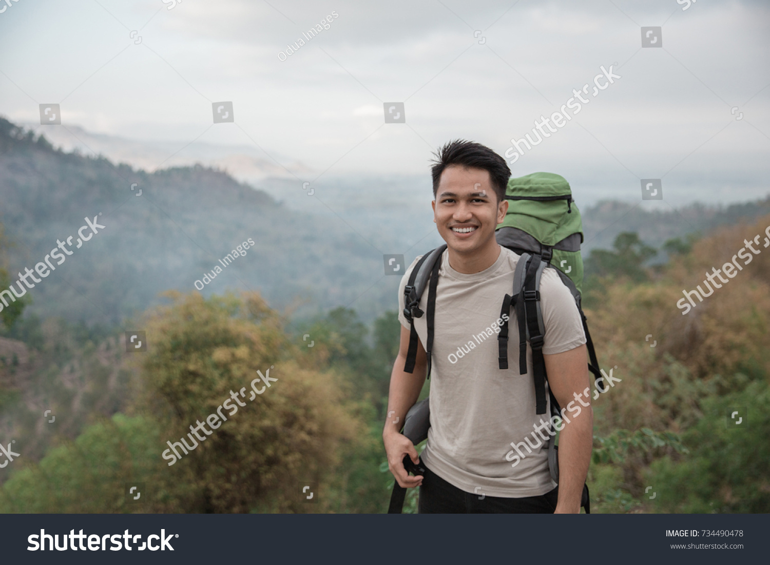 Happy asian hiker. man with backpack hiking in beautiful forest
