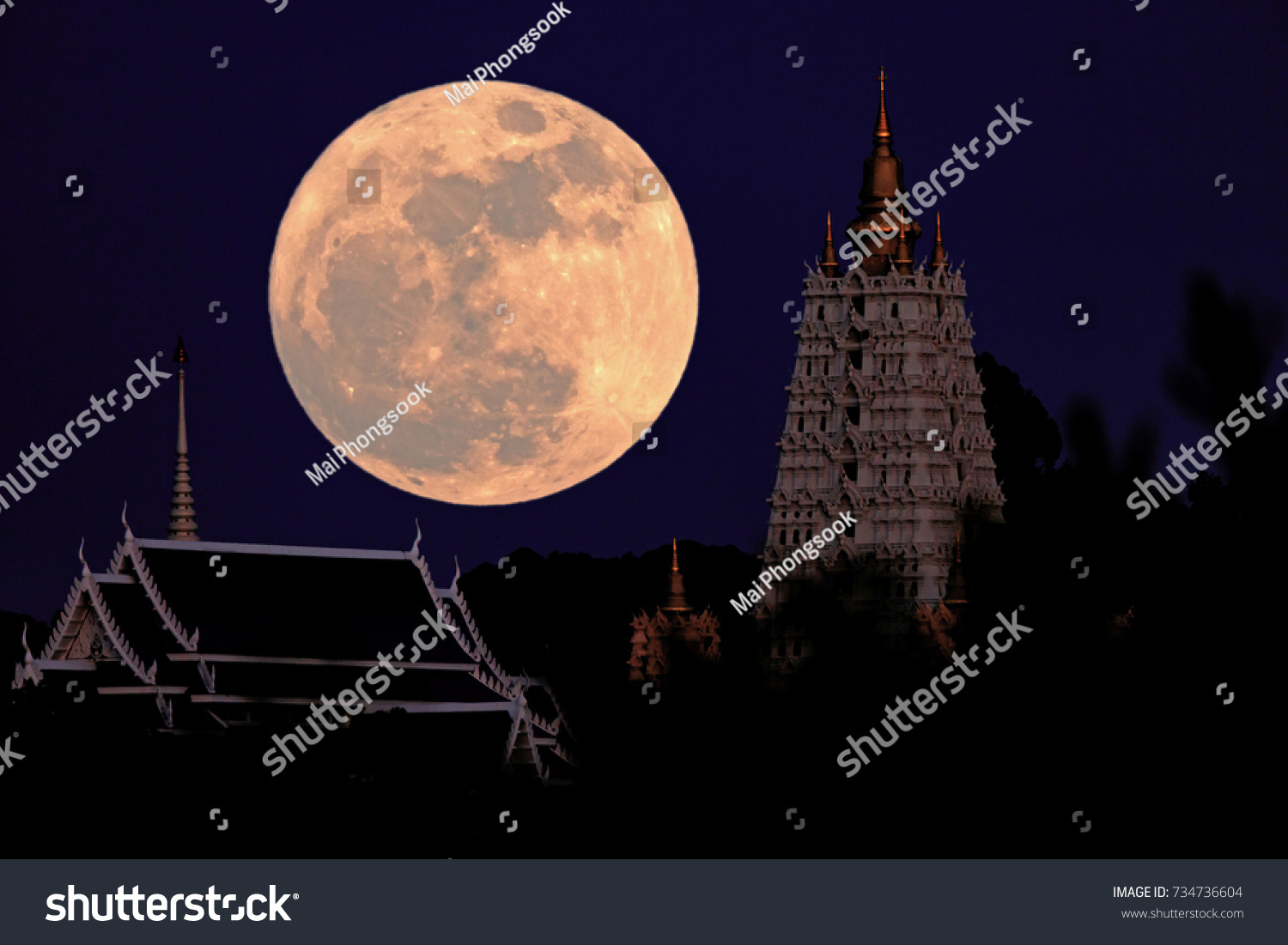 The big moon is above the pagoda.