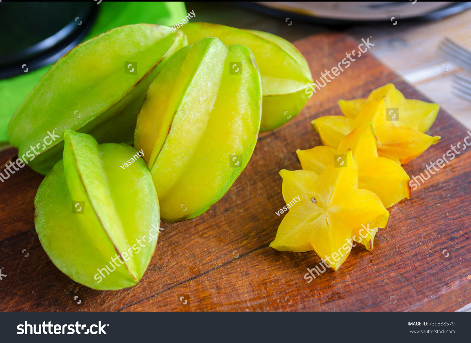 Exotic starfruit or averrhoa carambola on wooden cut board. Healthy food fresh organic star apple fruit. Carambolas background
