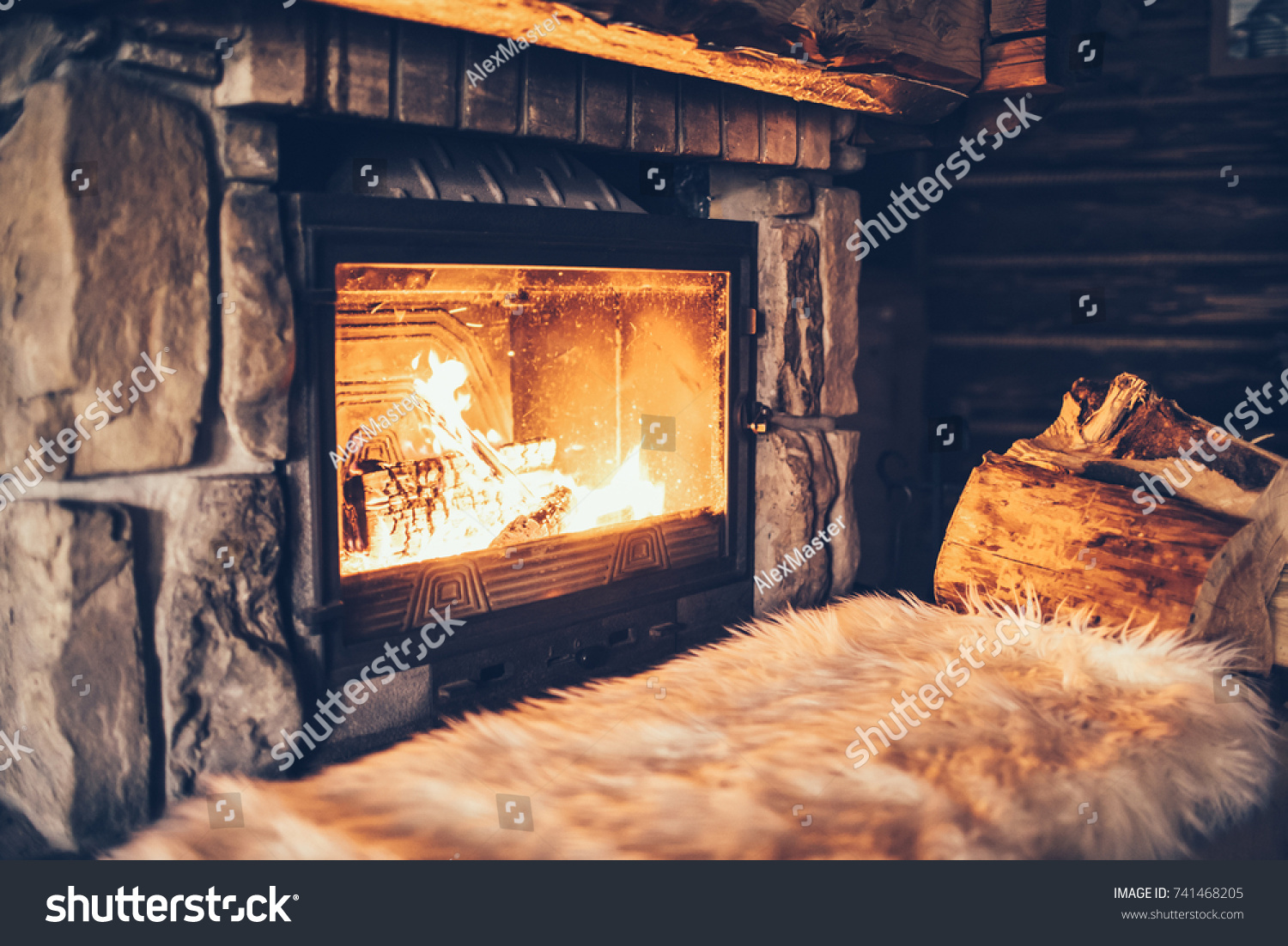 Warm cozy fireplace with real wood burning in it. Cozy winter concept. Christmas and travel background with space for your text.