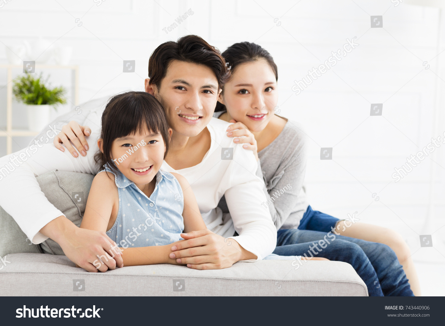 Happy asian family on sofa in living room