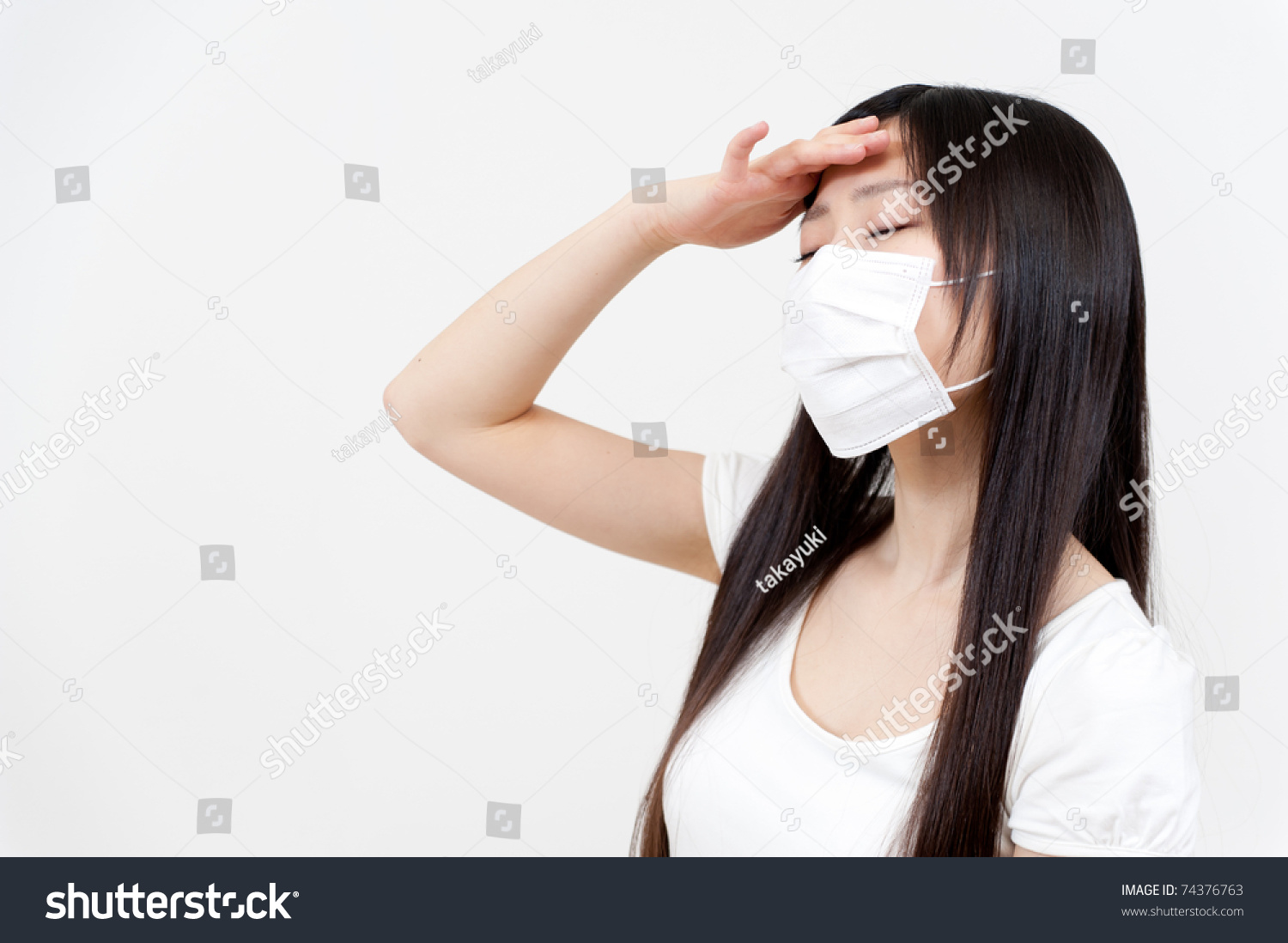 beautiful asian woman with a headache