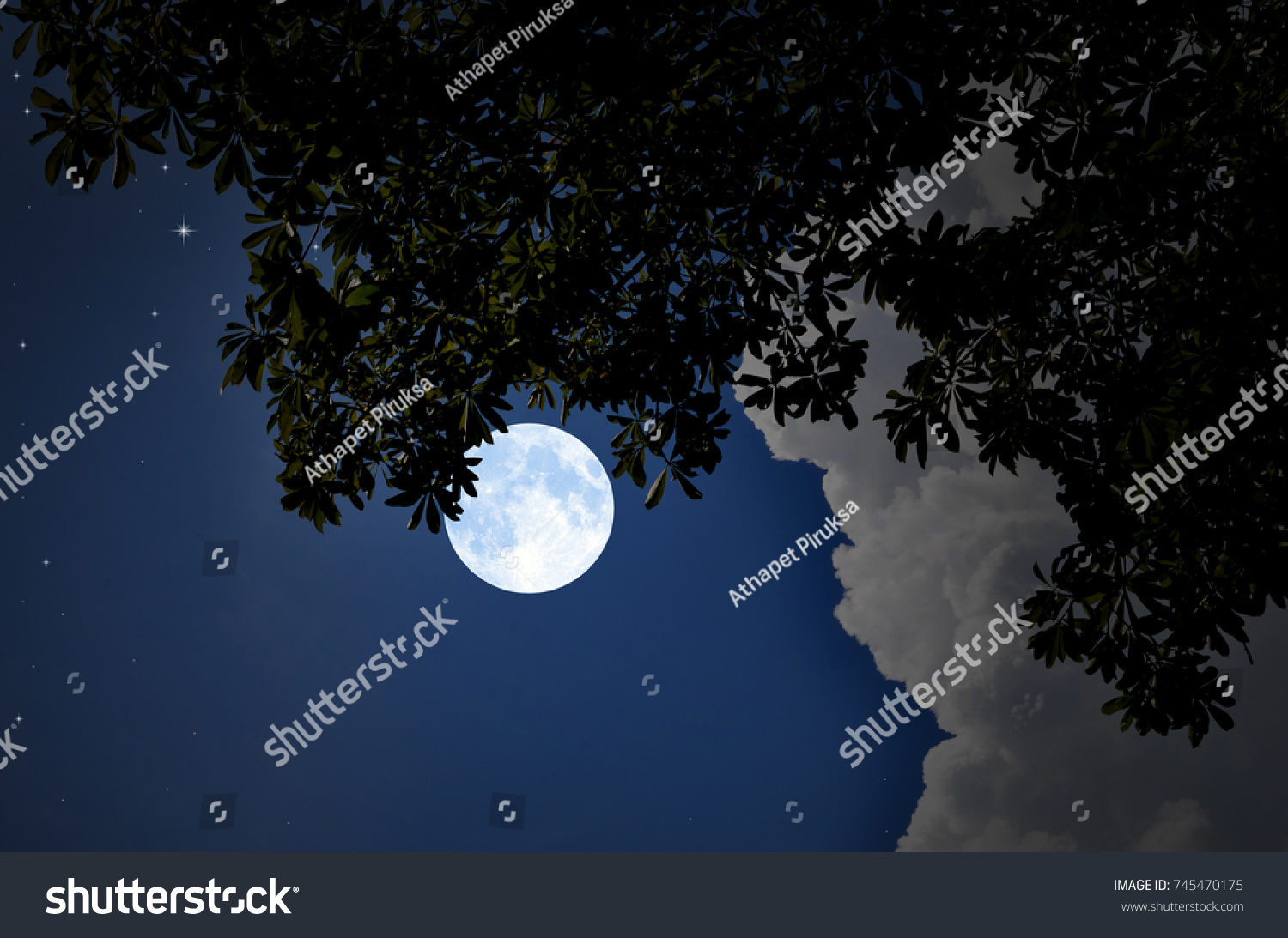 Bright moon and white clouds in blue night sky