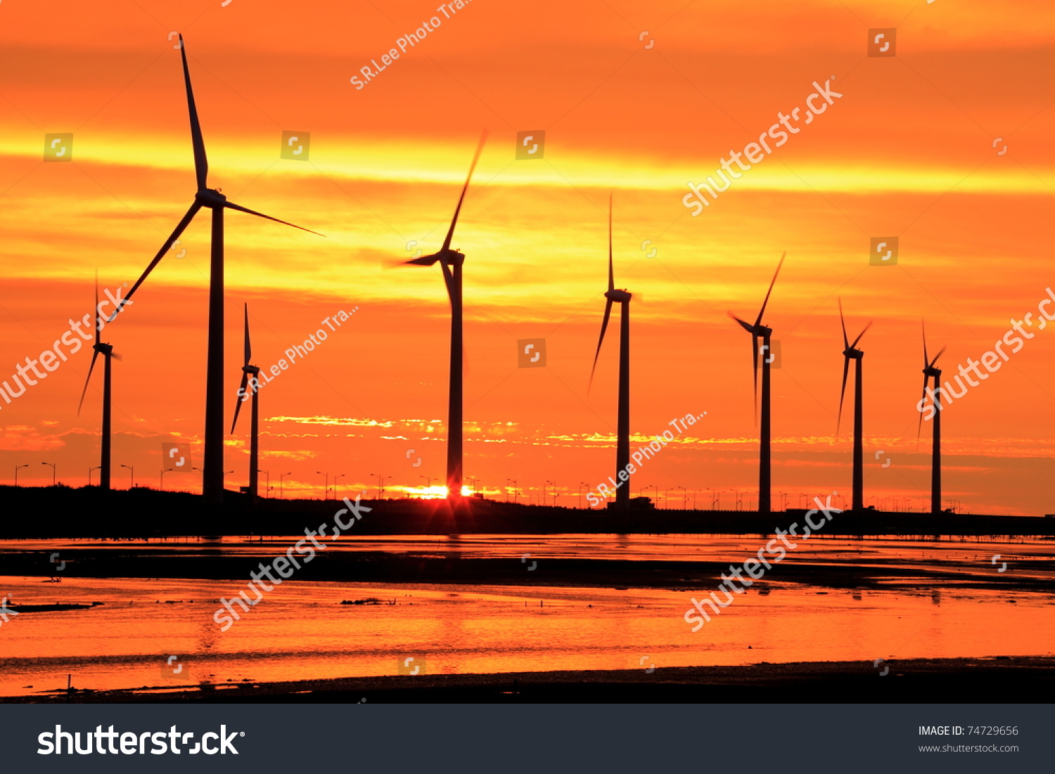 aerogenerator array silhouette at sea shore