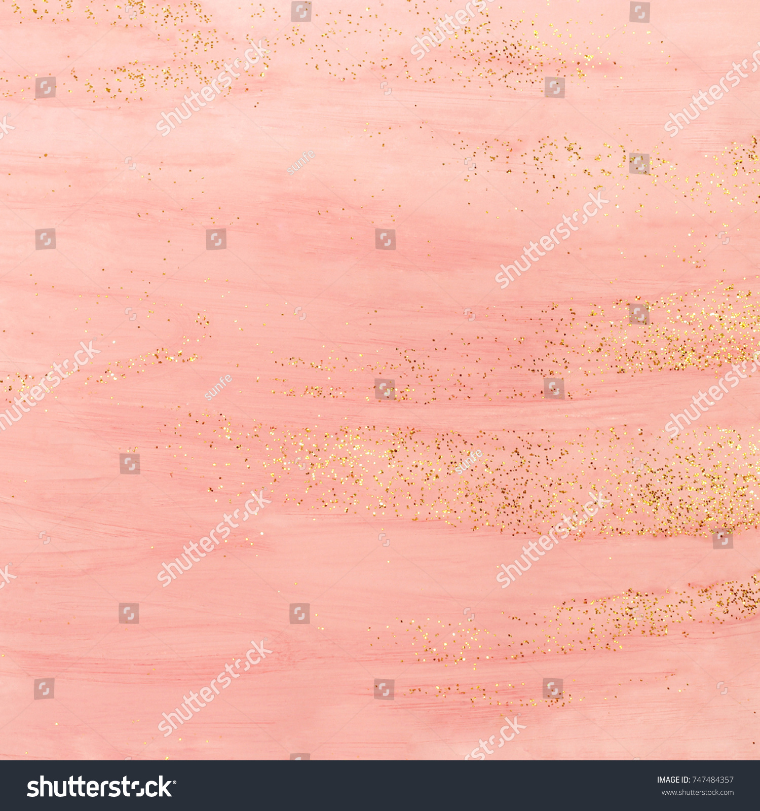 Pink watercolor background with golden glitter. Abstract hand painted backdrop.