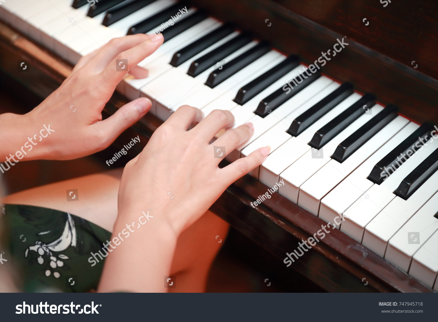 Close up human hands playing piano in Christmas party

