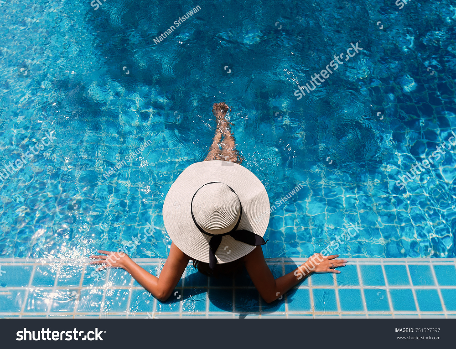 Young asian woman relaxing in swimming pool at spa resort.relaxing concept.