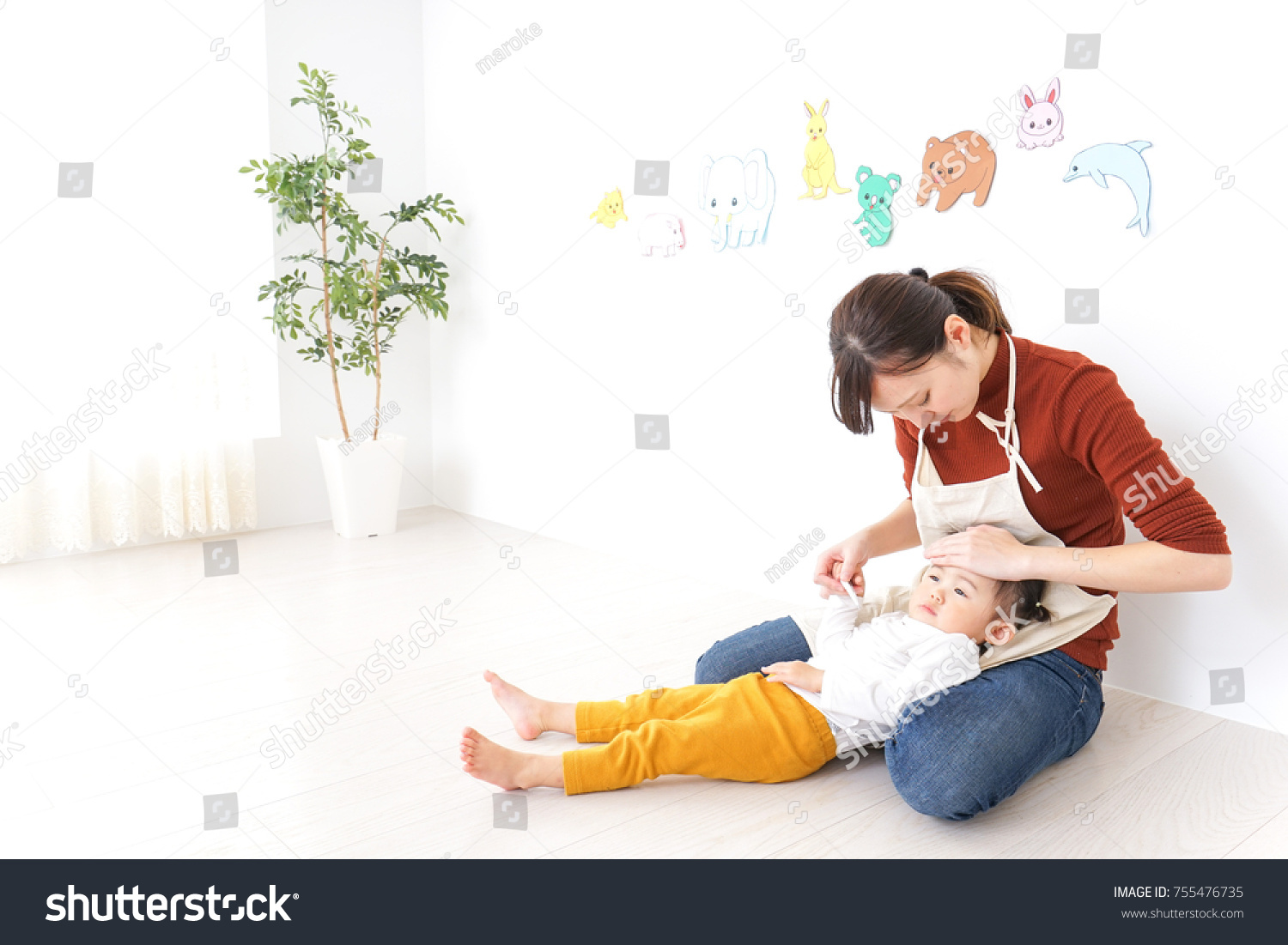 Nursery teacher care child having a cold