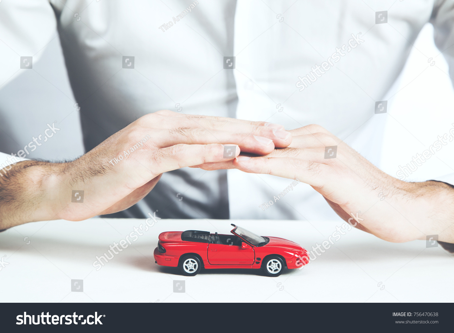Car insurance concept. Man and model of car  on table