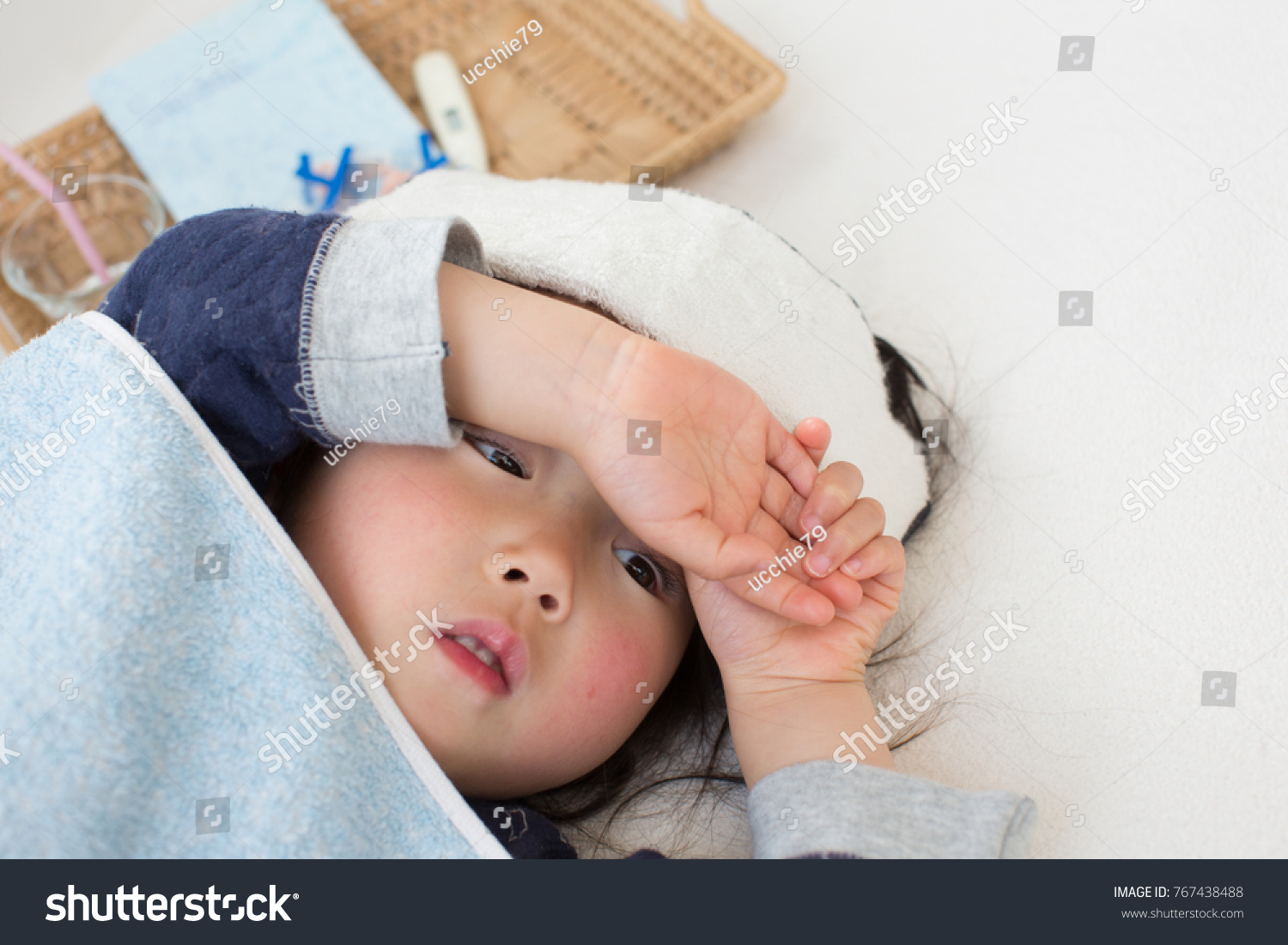 asian kid lying on bed