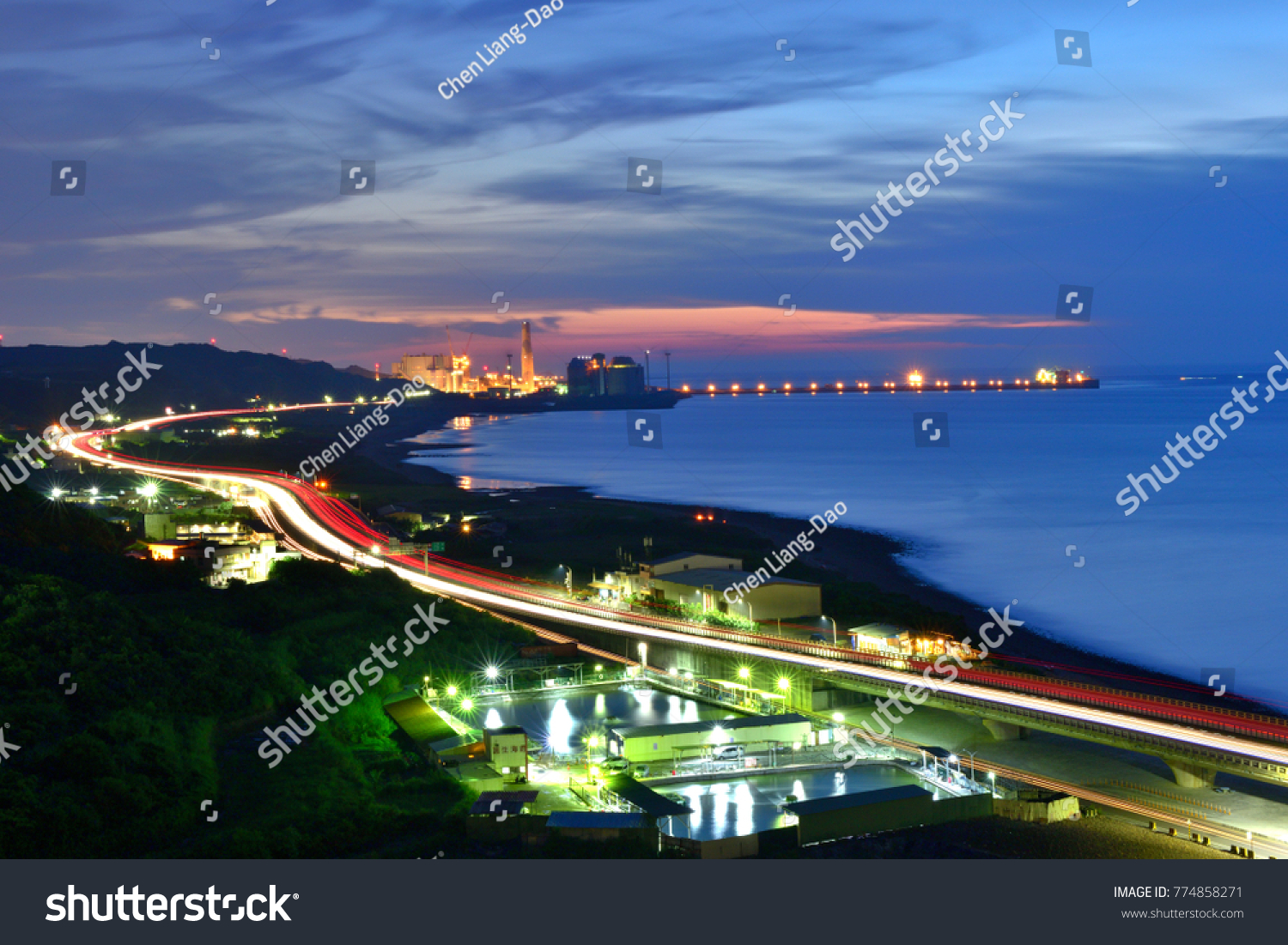 Busy harbor lights and elevated motorway light trails on the highway look very beautiful at night after sunset Taipei's new Taipei Port