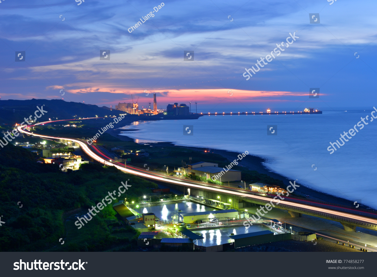 Busy harbor lights and elevated motorway light trails on the highway look very beautiful at night after sunset Taipei's new Taipei Port