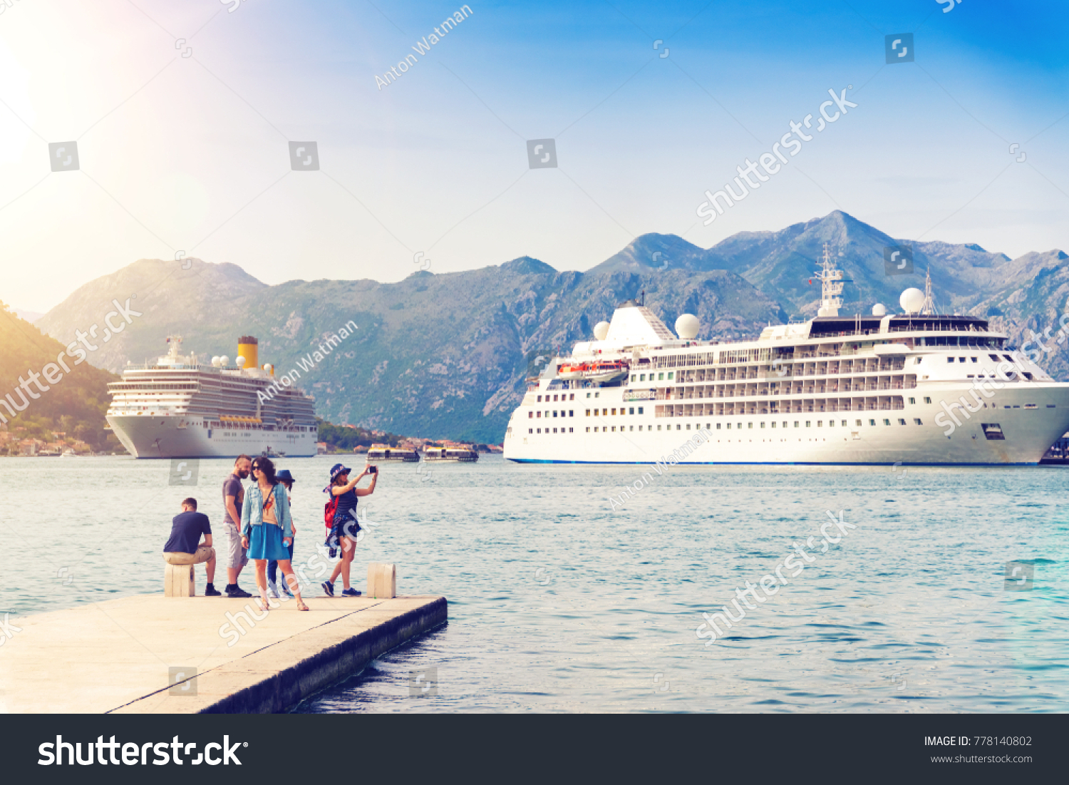 Group of tourists in the port with big cruise ships