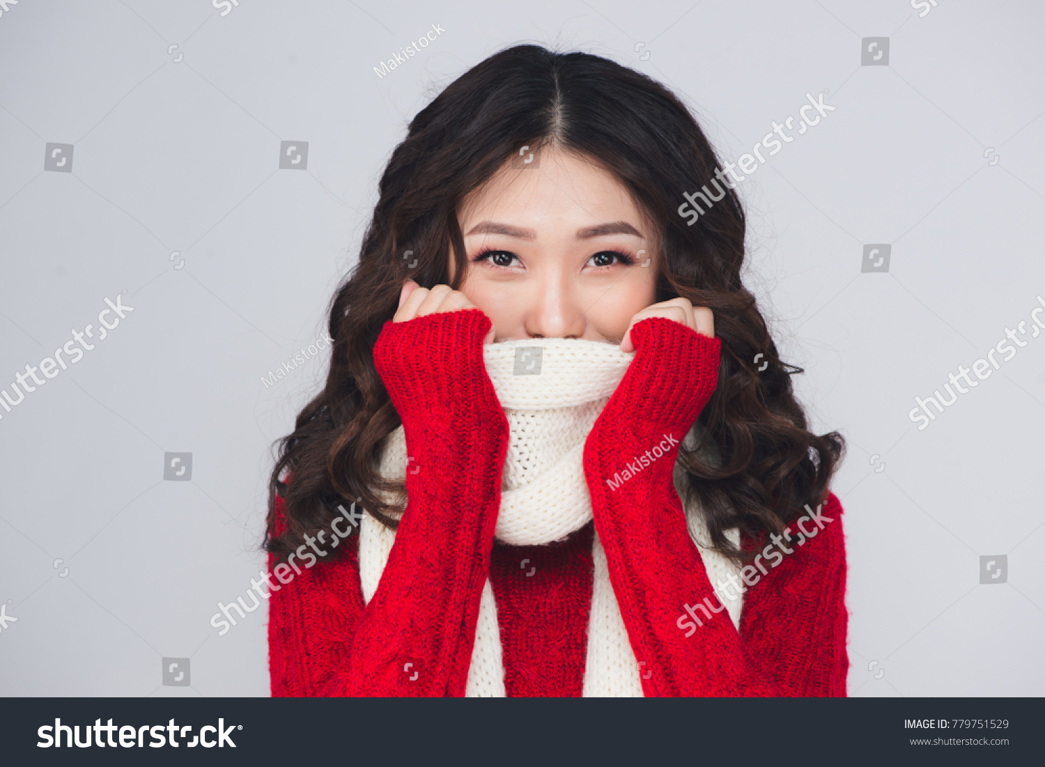 Beautiful smiling fashion model face with red lips in warm clothing
