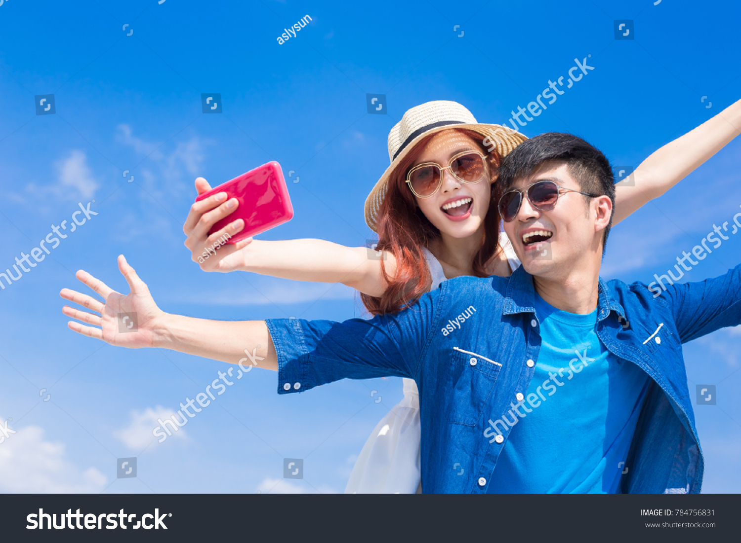 couple selfie happily with the blue sky