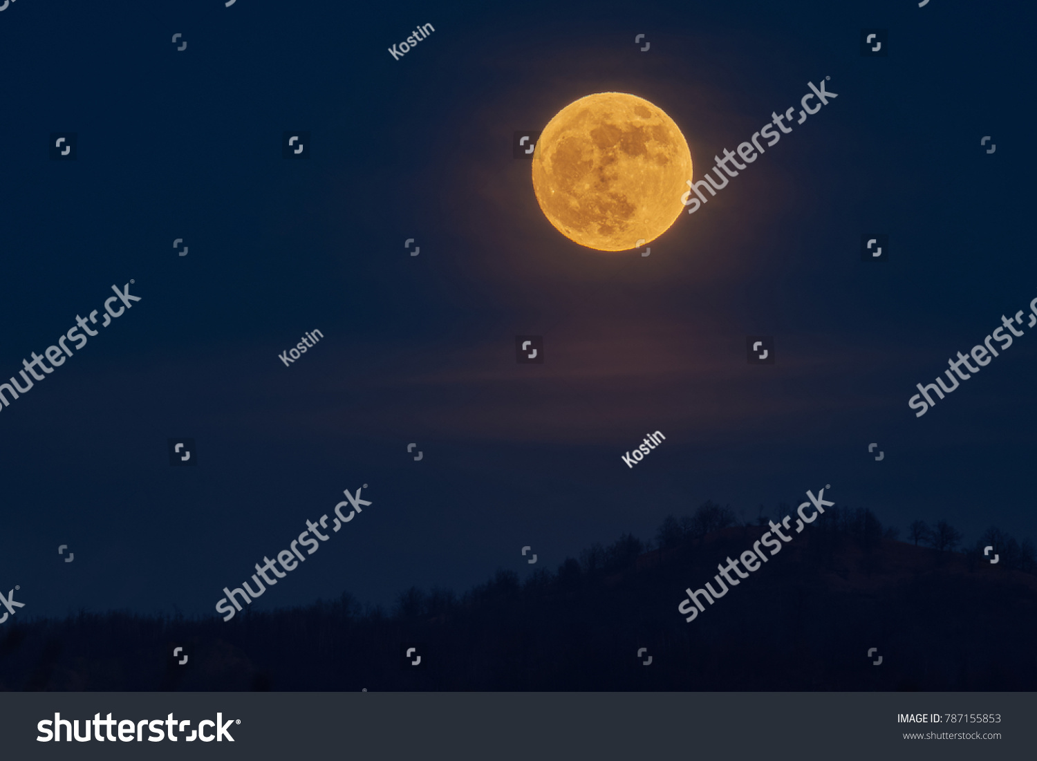 Full yellow moon over the hills in the first day of the year