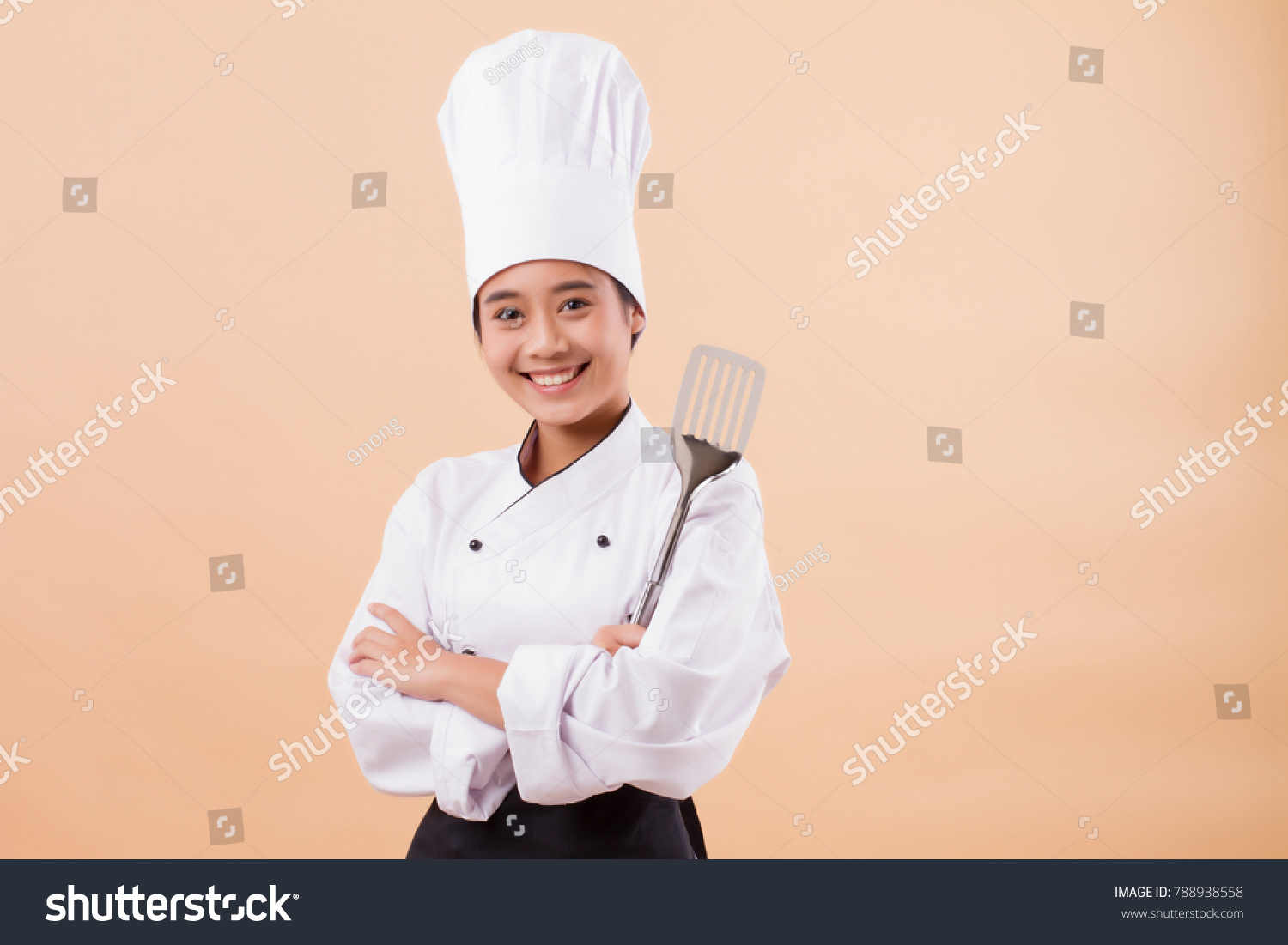 woman chef holding spatula cooking equipment
