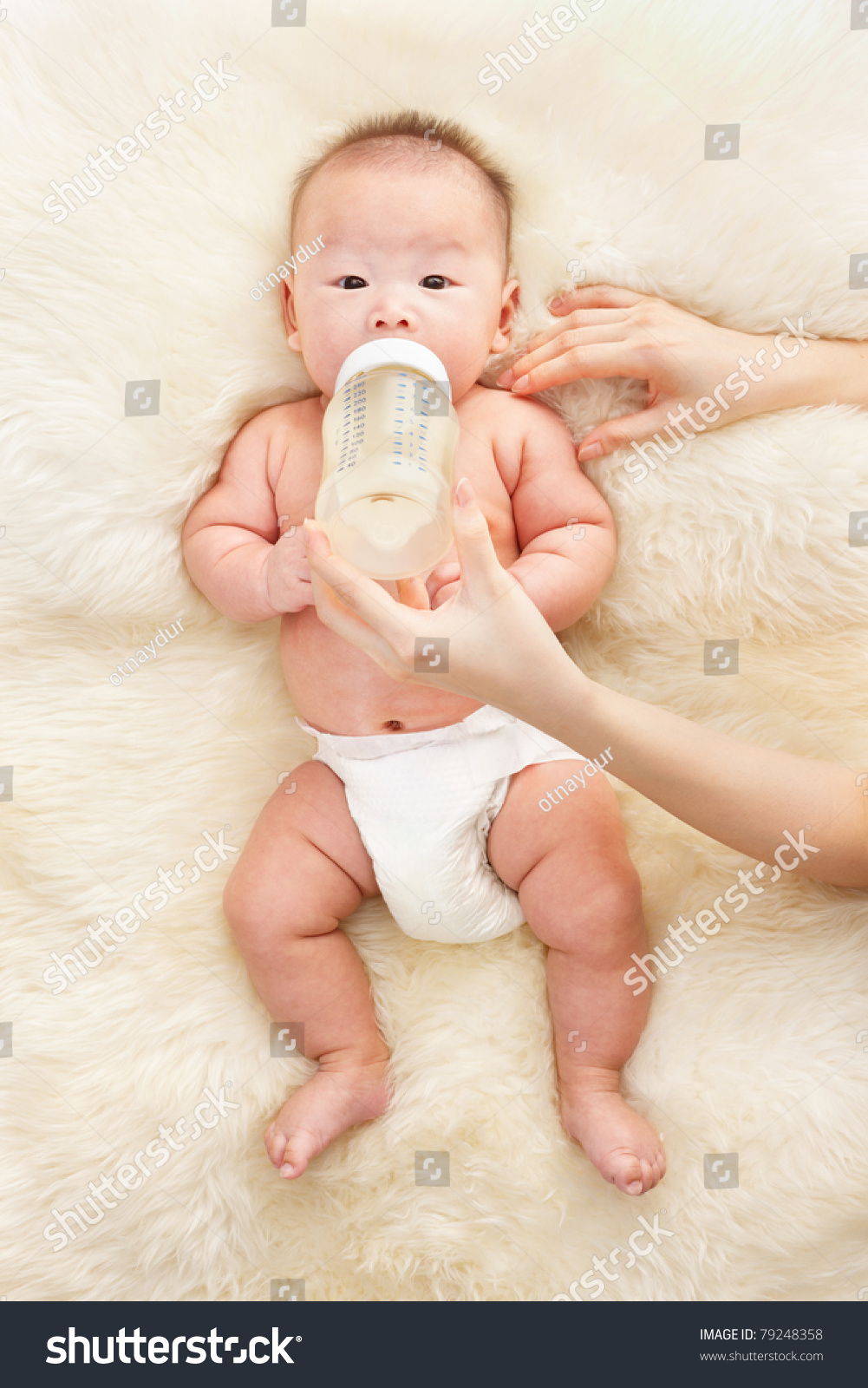 Chinese baby boy feeding milk from baby's bottle