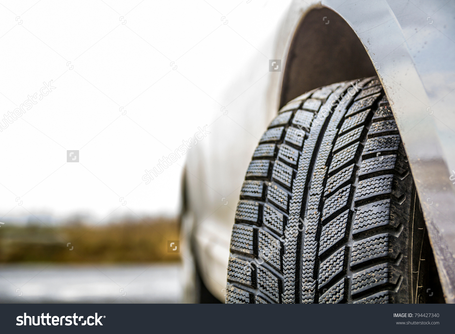 Close-up image of car wheel with black rubber tire