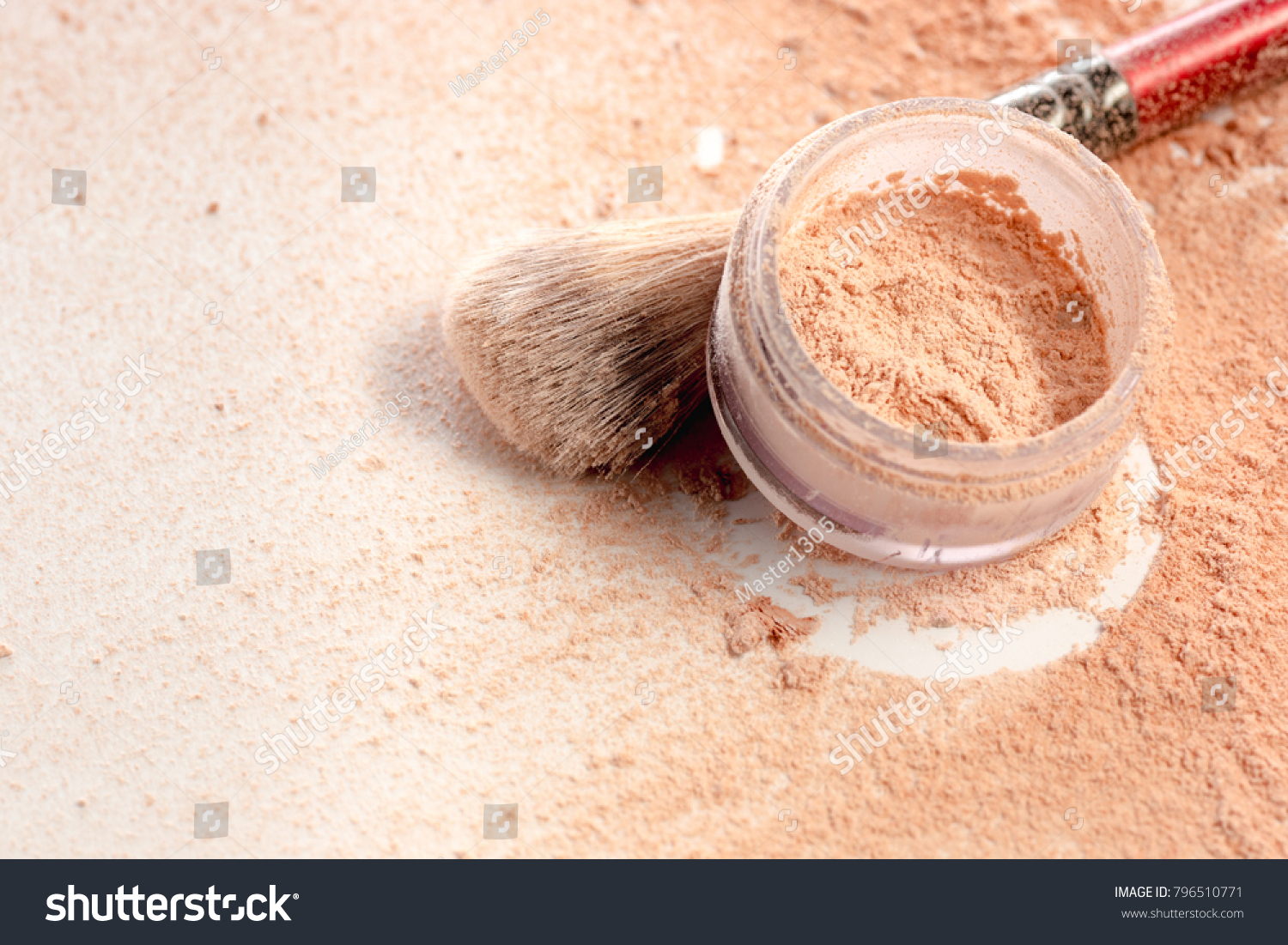 Close-up of crushed mineral shimmer powder golden color with makeup brush