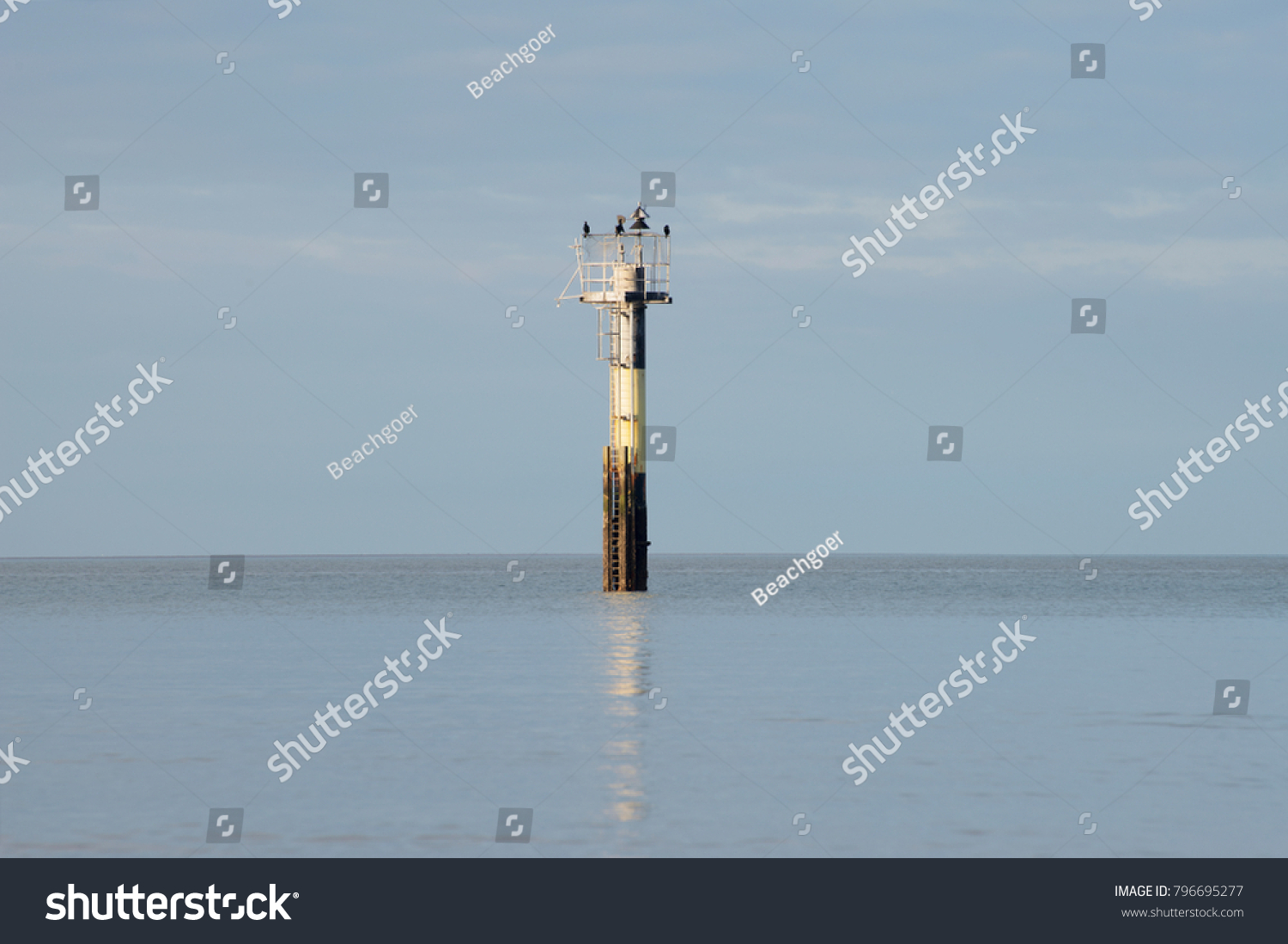 An example of a Light Beacon which could also be called a Seamark and which guides ships into maritime channels or warns them of hazards. Cormorants use this as a convenient perch.
