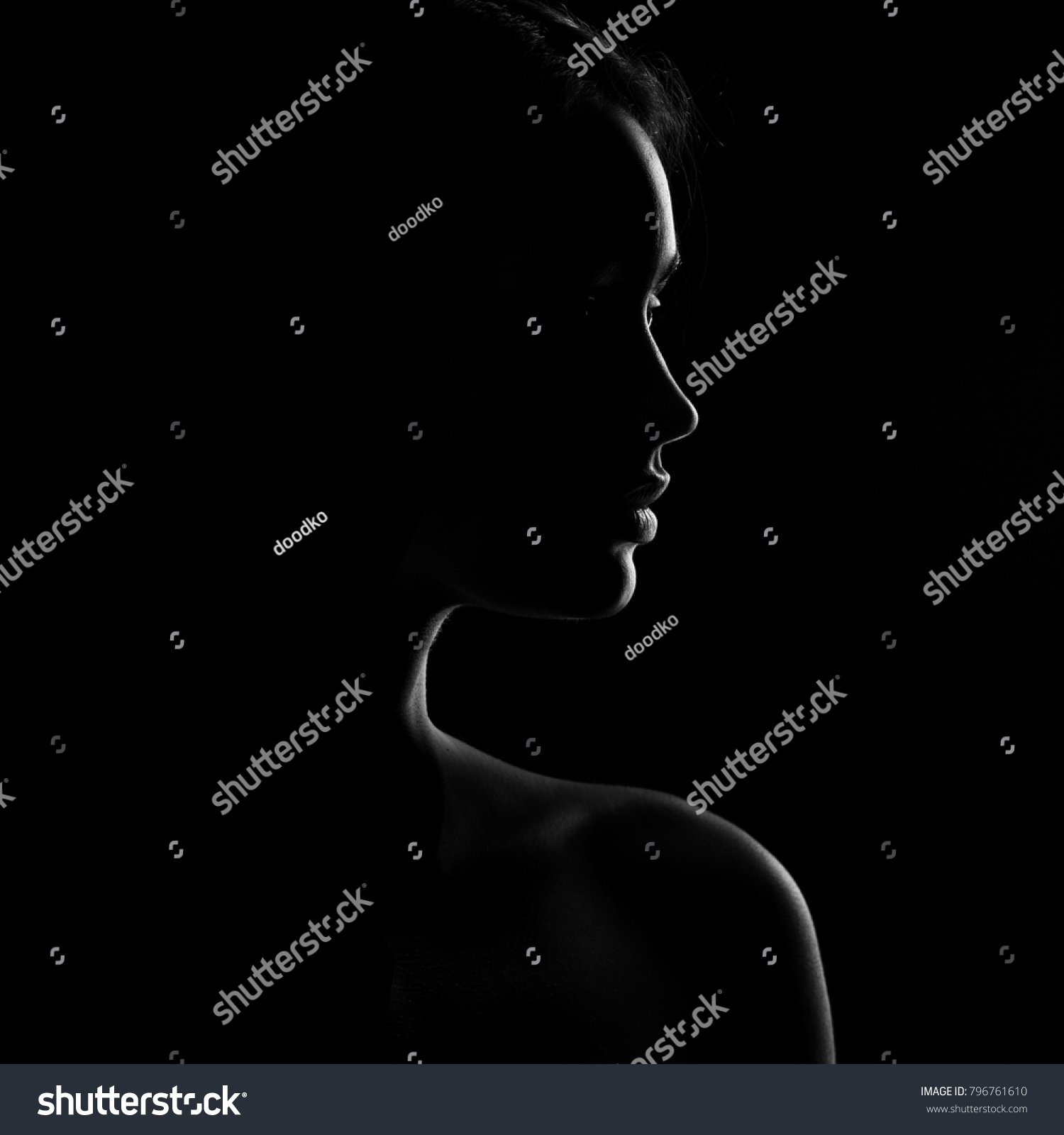 silhouette of beautiful young woman isolated on black background
