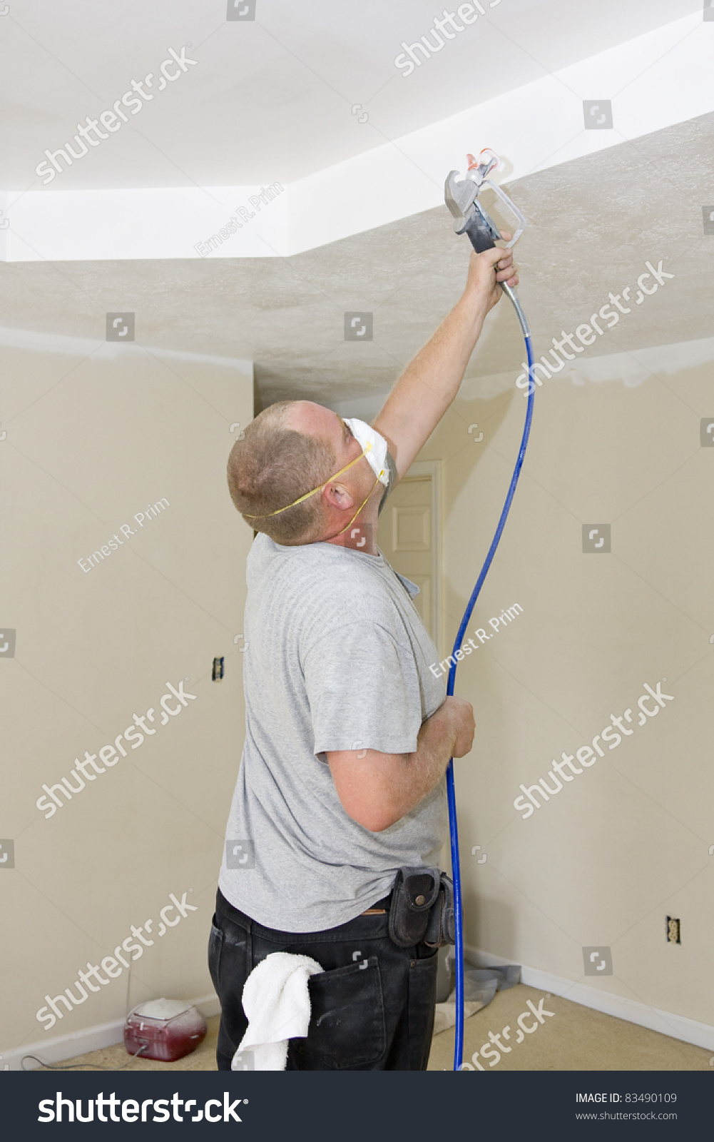 Contract painter updating colors of walls and painting ceilings bright