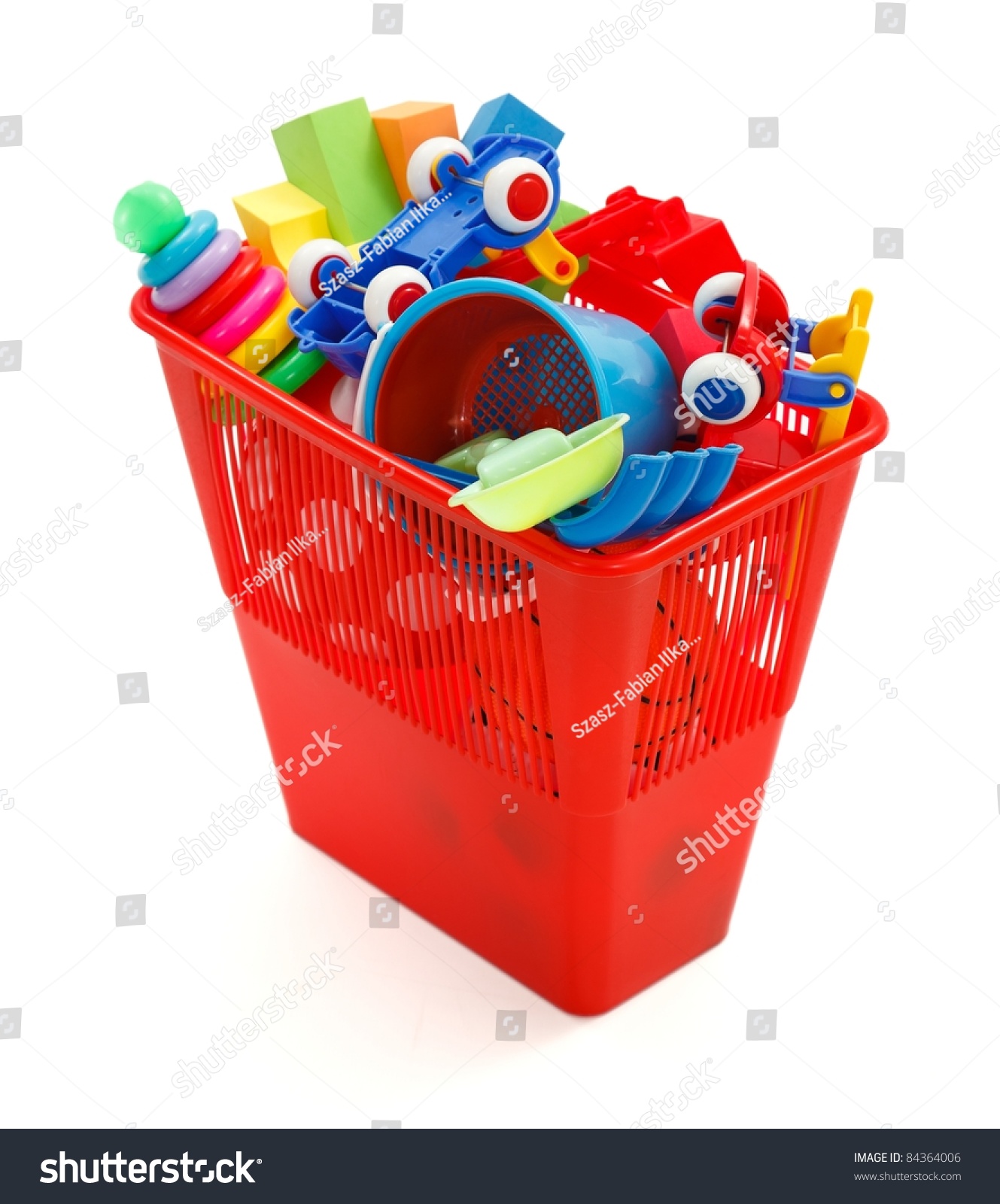 colorful plastic toys thrown away in garbage bin