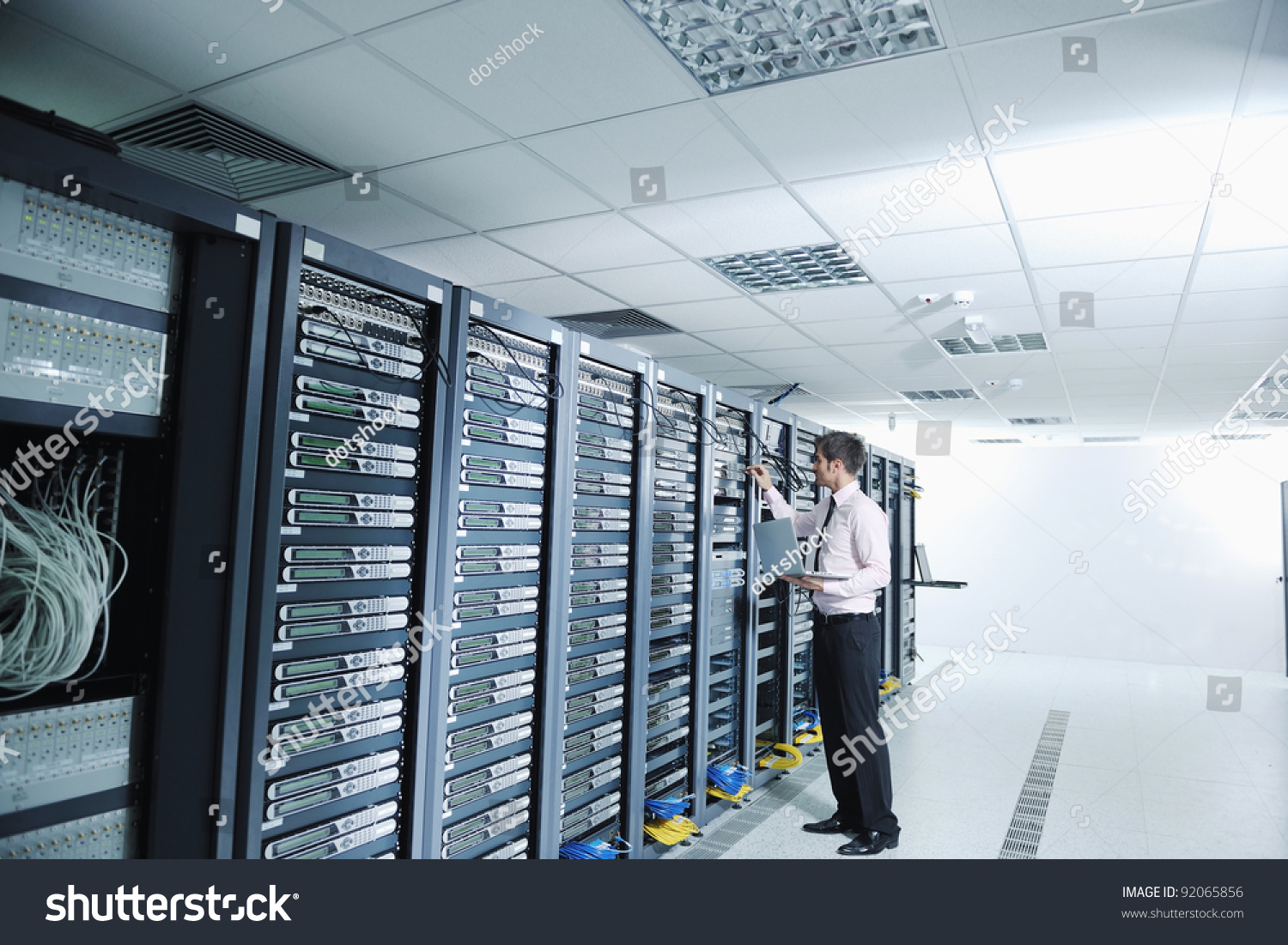 young handsome business man  engeneer in datacenter server room