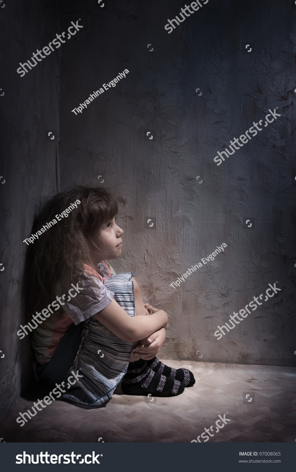 child alone in a dark corner