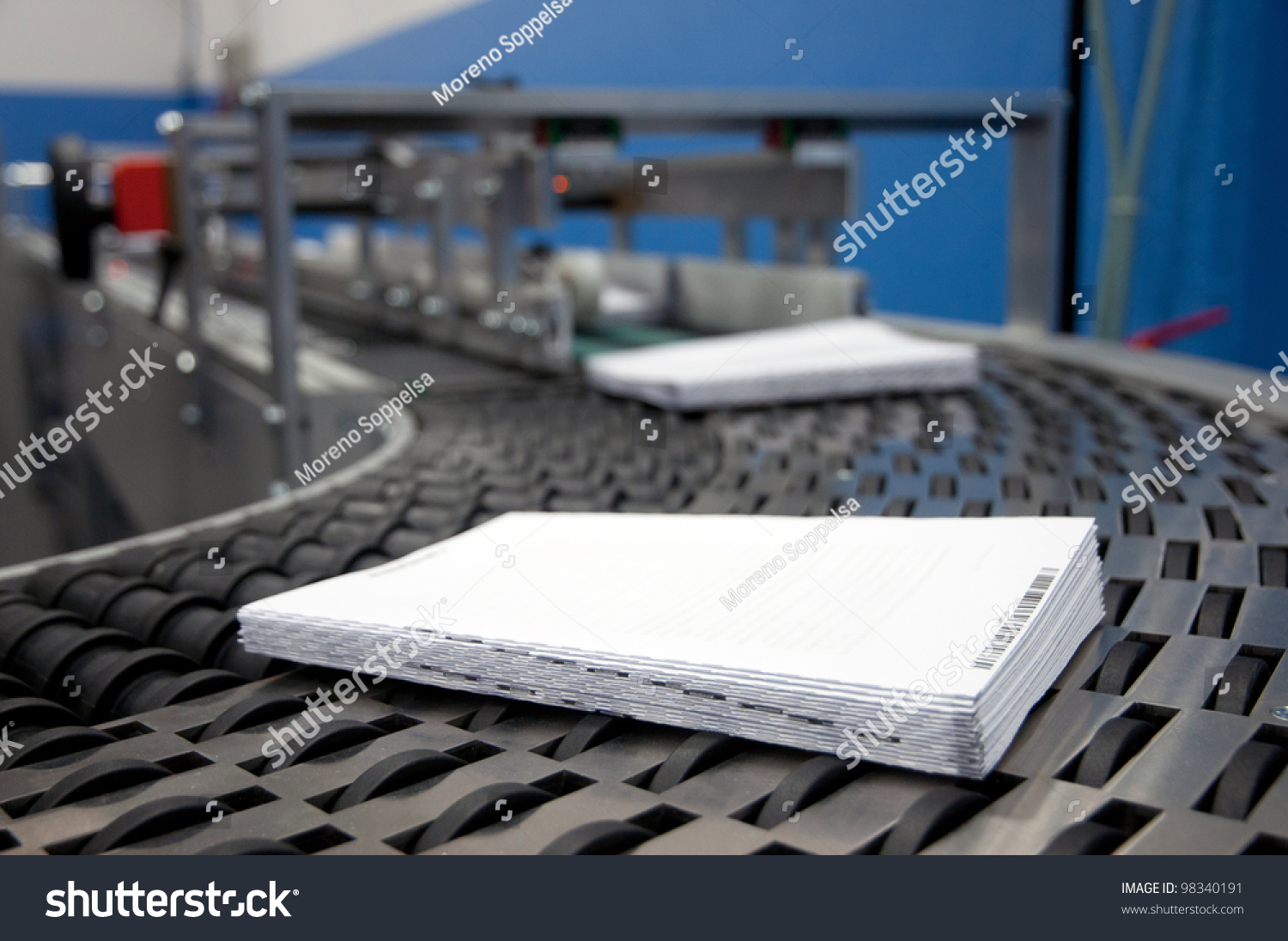 Print shop (press printing) - Finishing line. Post press finishing line machine: cutting trimming paperback and binding
